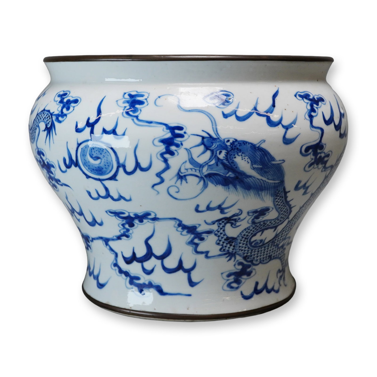 Blue and White Dragon Vase with Copper Rim: This porcelain vase features a bulbous body tapering down to a flared foot and rising to a wide mouth mounted with a fitted copper rim band. The underglaze blue decoration features large imperial drag