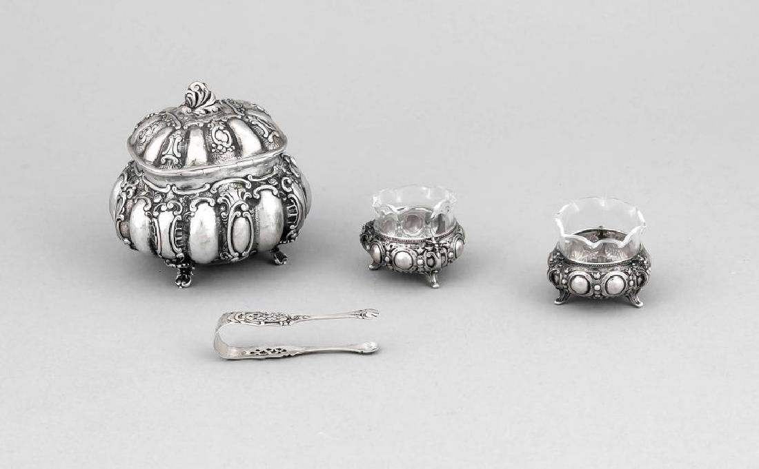 Compilation of four pieces, partly German, 20th cent.,: Compilation of four pieces, partly German, 20th cent., silver various fineness respectively tested, sugar bowl, sugar tongs and 2 salt cellars with supplemented glass inserts, l. up to 10 cm, total we