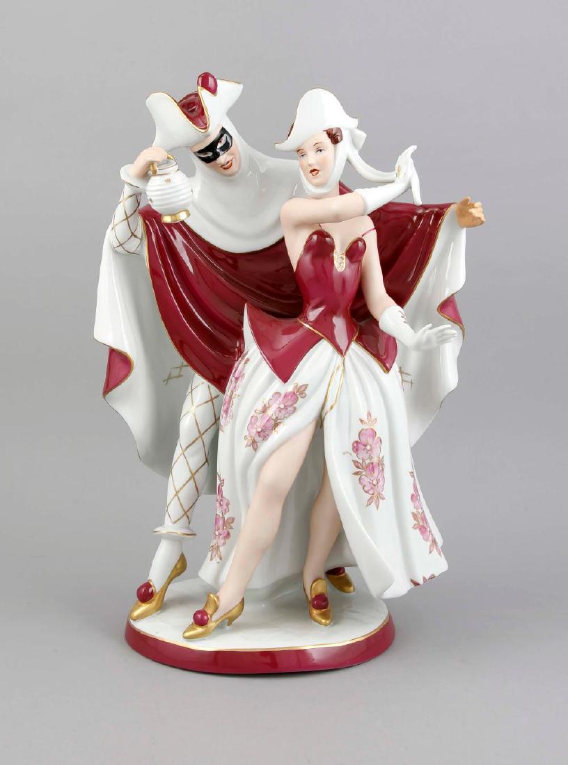 Carnival, Royal Dux, Bohemia, late 20th century,: Carnival, Royal Dux, Bohemia, late 20th century, dancing couple, man with mask and lantern, on oval pedestal, painted in purple and gold, model no. 204, hand rest., H. 50 cm Description: Carnival, Roy