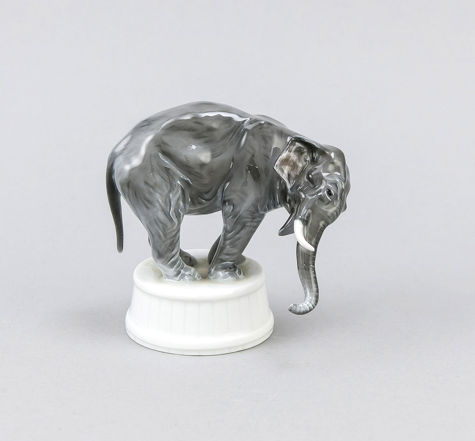 Elephant on pedestal, Rosenthal, Selb, 1920s, designed: Elephant on pedestal, Rosenthal, Selb, 1920s, designed by Fritz Diller (1875 - 1945 Munich) in 1913, model no. 335, naturalistic painted in underglaze colors, h. 9 cm