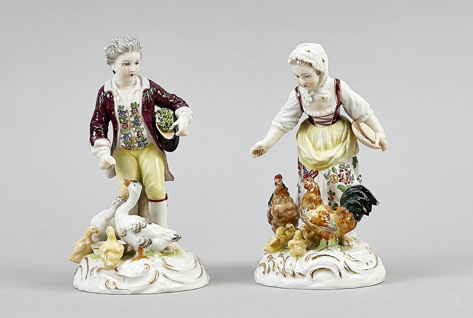 Two groups of figures, Ru: Two groups of figures, Rudolstadt, Thuringia, 20th boy, feeding the goose family, girl feeding the chicken family, finger min. chipped, on round base, polychrome painted, gilted, h. 13.5 cm