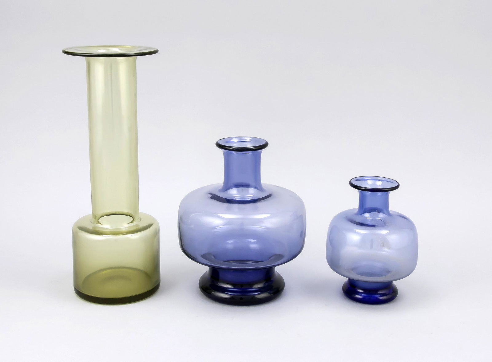 Three vases, Denmark, Hol: Three vases, Denmark, Holmegaard, design probably Per Lütken (1916-1998), design of the 1950/60s, different shapes and sizes, blue resp. yellowish-green glass, in the stand signed and numbered, h. 13