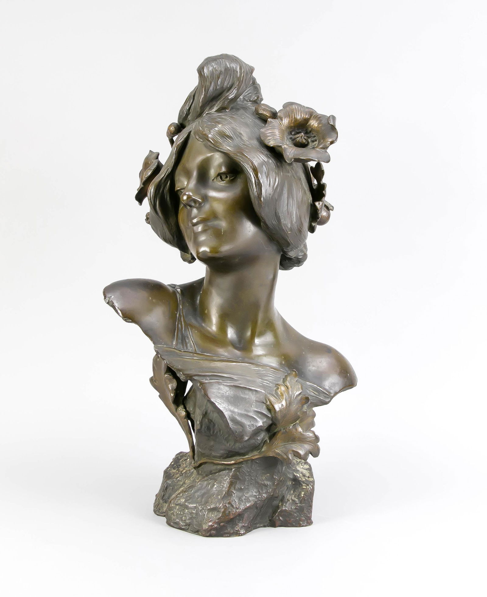 Julien Causse (1869-1909): Julien Causse (1869-1909), French sculptor of the Art Nouveau, bust a nymph with flowers in the hair and foliage on the rocky pedestal, patinated bronze, laterally sign. J. Causse, patina somewhat blo