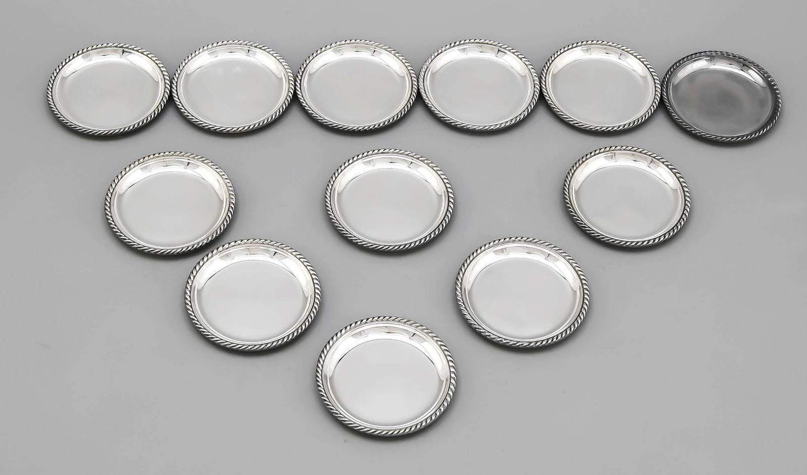 Twelve trivets, German, 20th century, hallmarked Gebr.: Twelve trivets, German, 20th century, hallmarked Gebr. Deyhle, Schwäbisch Gmünd, Sterling silver 925/000, cord relief rim, Ø 8 cm, total weight approx. 412 g