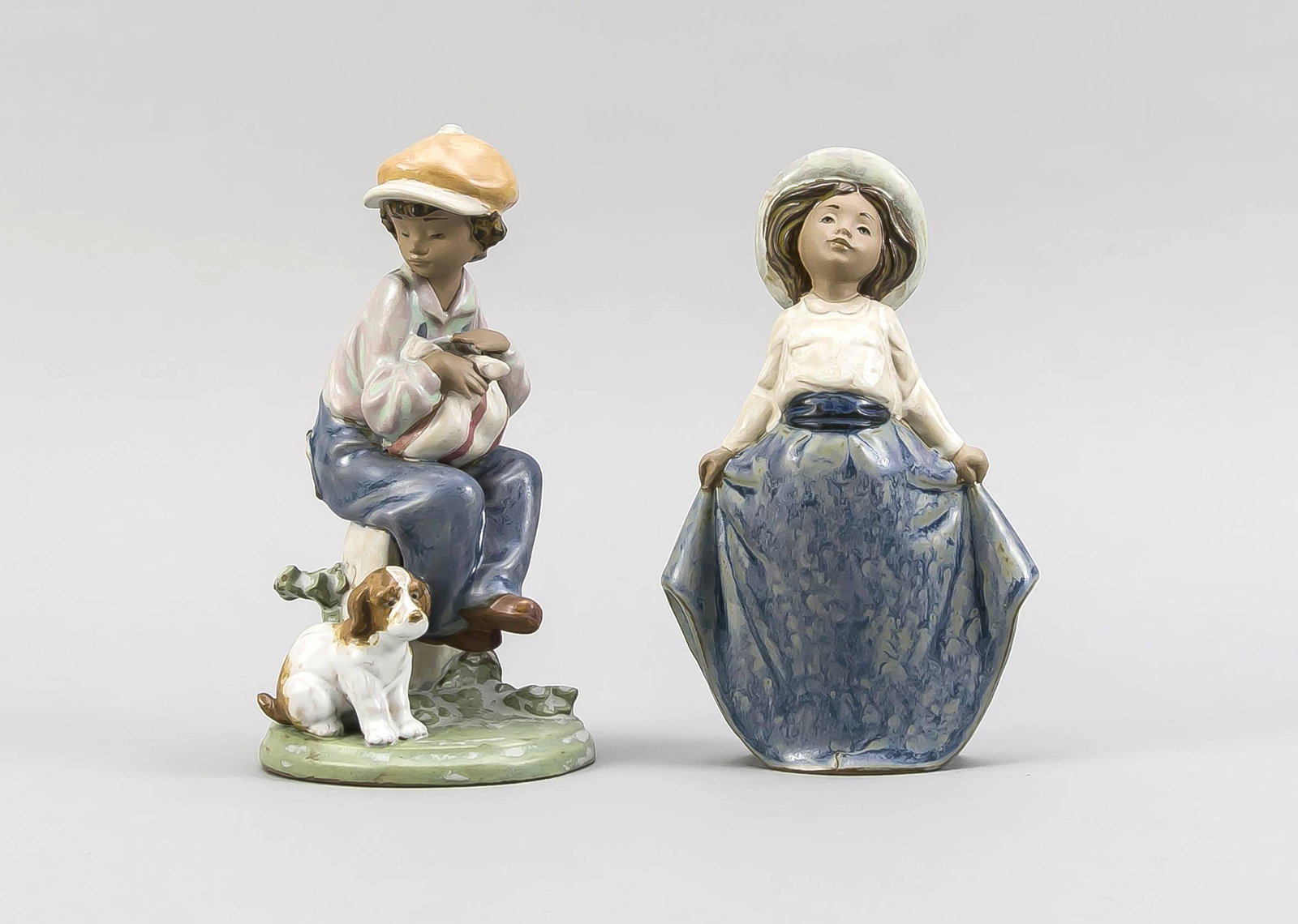 Pair of figurines, Lladro, Spa: Pair of figurines, Lladro, Spain, late 20th century, marked underneath a. with model no., ceramic, polychrome painted, girl with hat 'Ninita recogiendose la falda' a. boy with puppy 'Golfillo con perr
