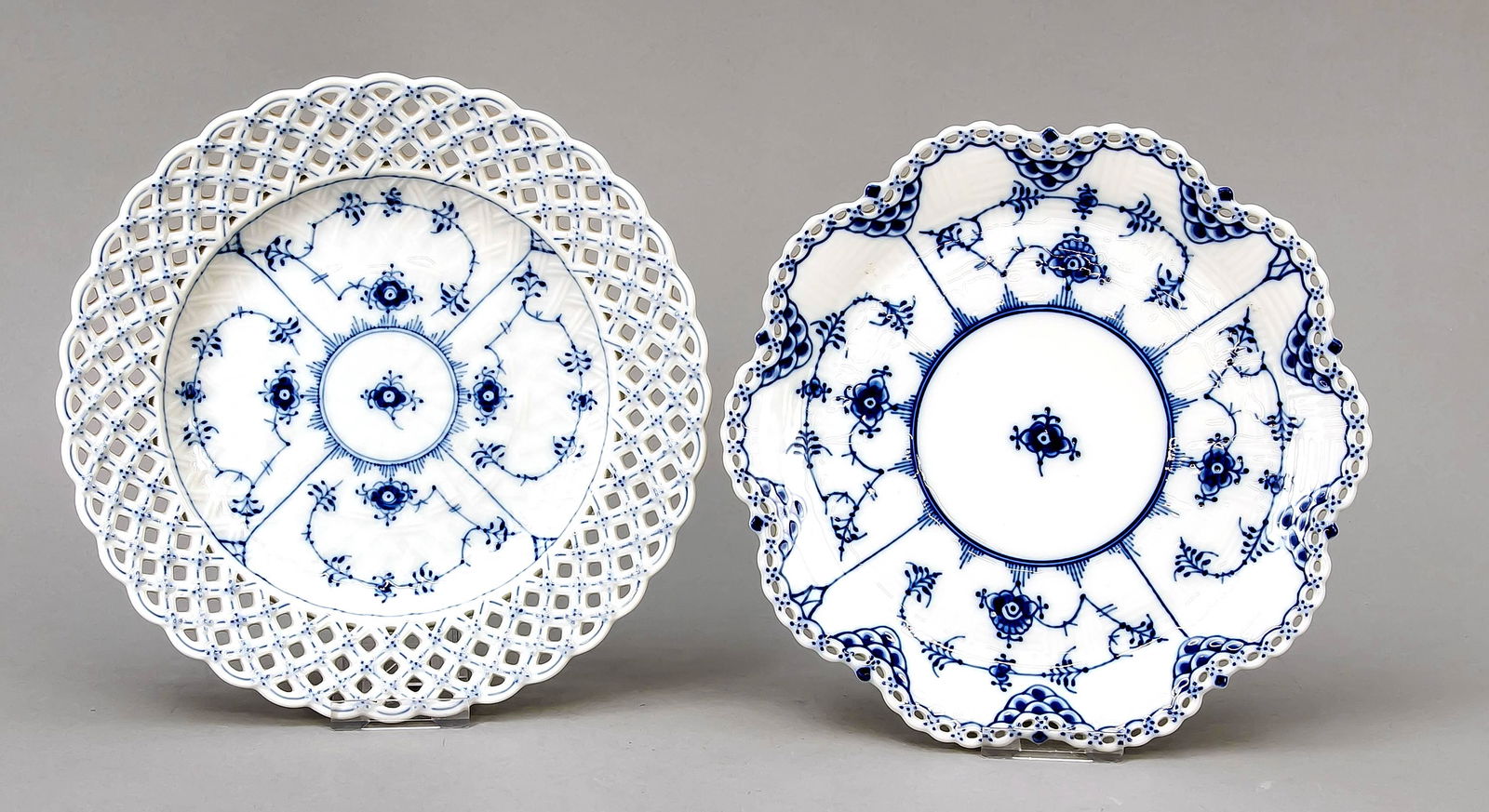 Two breakthrough plates, Royal: Two breakthrough plates, Royal Copenhagen, late 20th century, 1st quality, Muselmalet full lace decor in underglaze blue, designed by Arnold Krog (1856-1931) in 1888, model no. 1098, Ø 25.5 cm, model