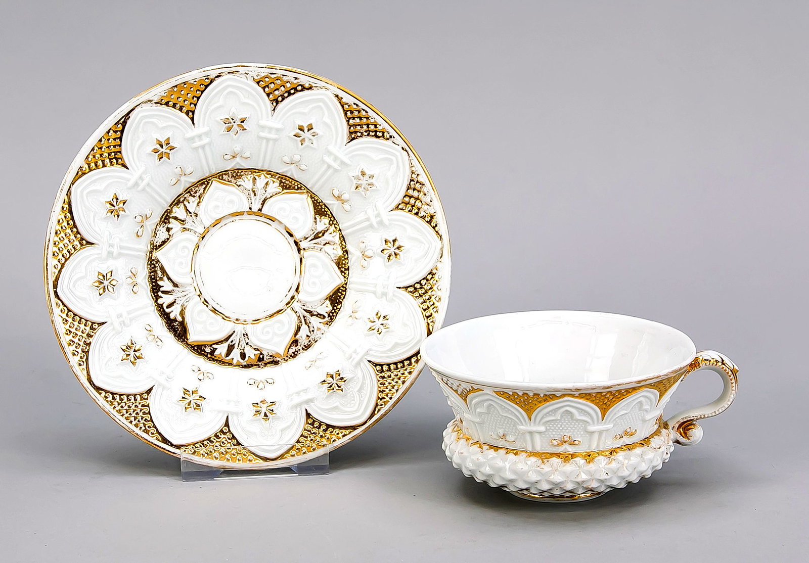 Cup with sauser, Meissen,: Cup with sauser, Meissen, beginning 19th century, relief surface with Gothic arched pointed windows, gilding partly rubbed off, h. 6 cm