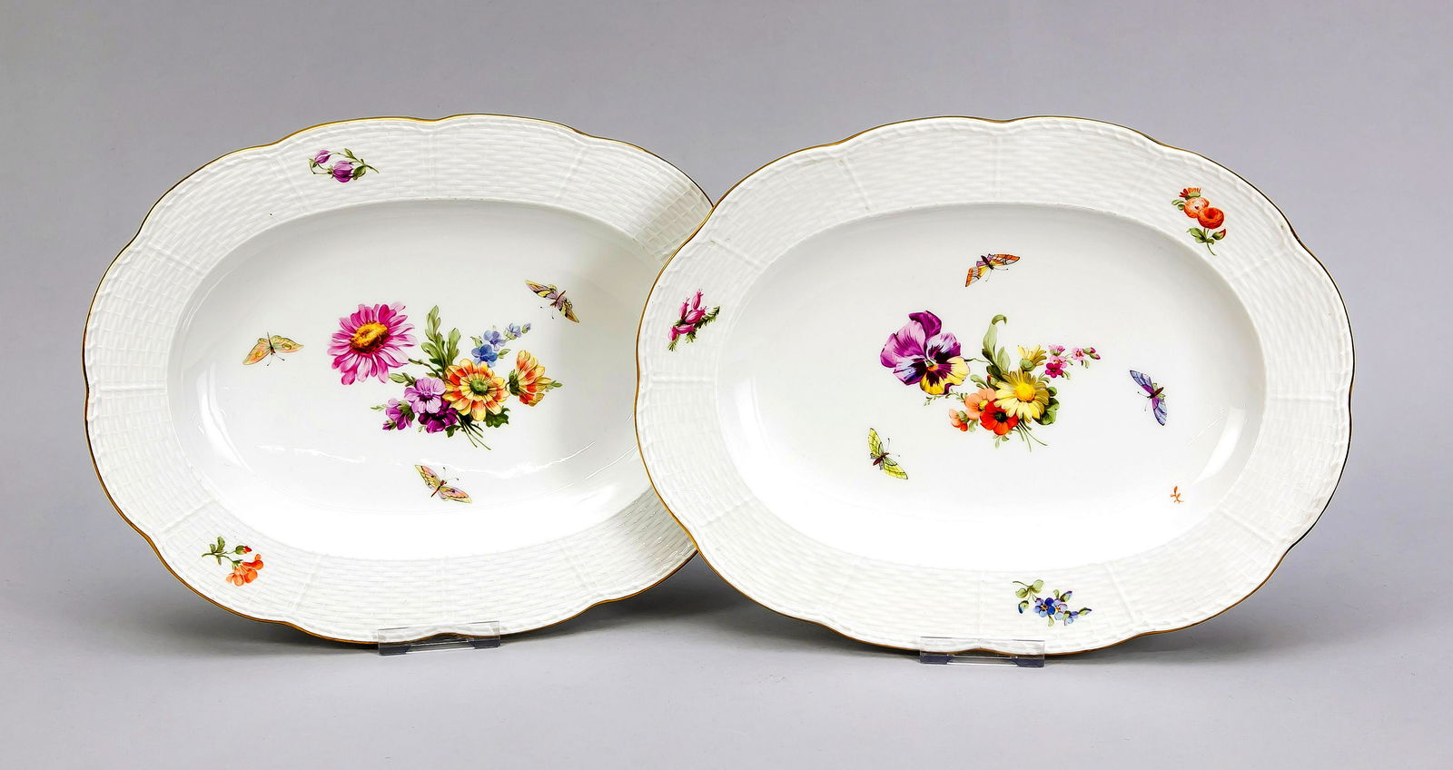 Two serving plates, KPM B: Two serving plates, KPM Berlin, beginning 20th century, 1st quality, red painters mark, form Ozier, polychrome flower and insect painting, gold rim, L. 31 cm