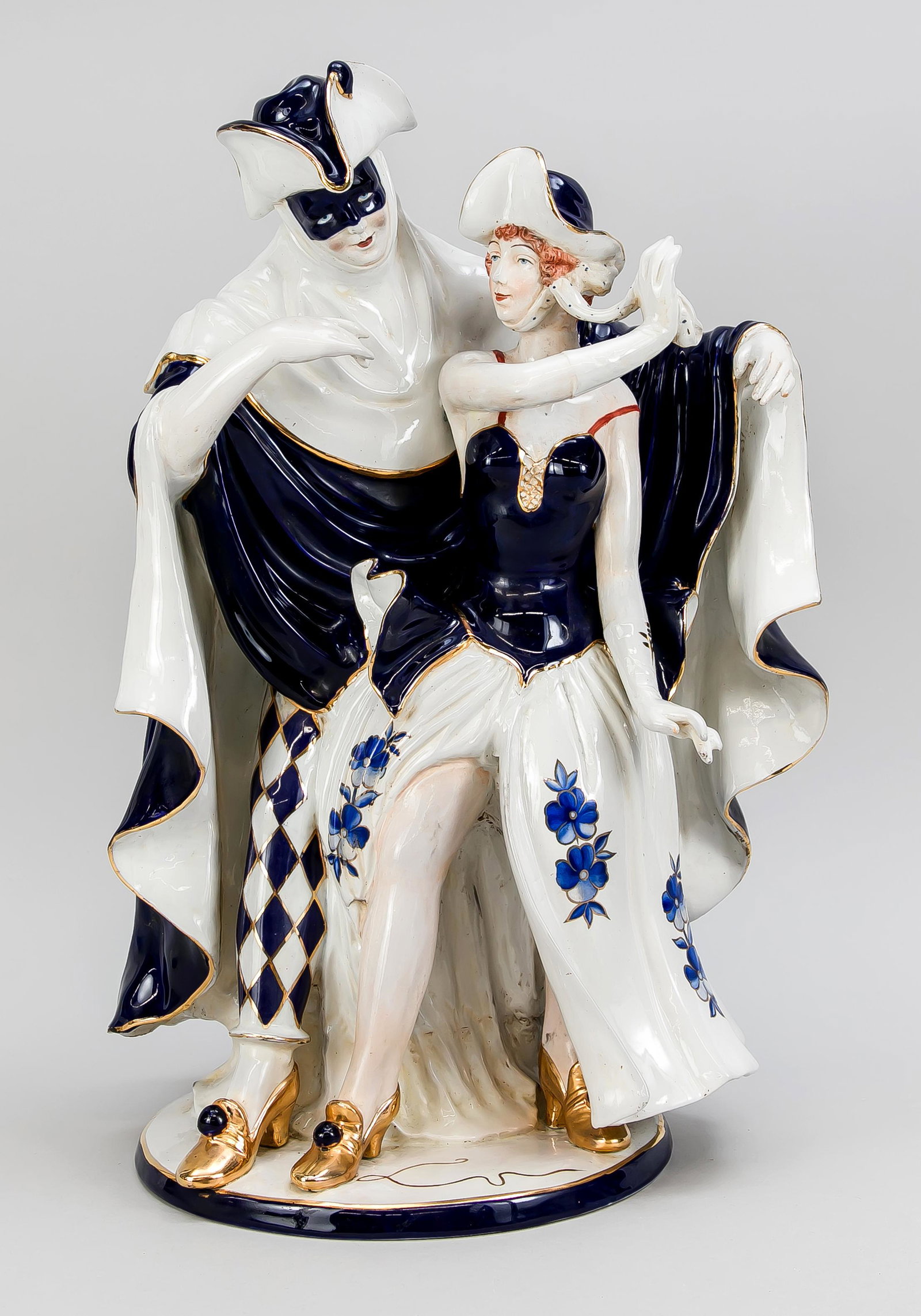 Large figurine group, Car: Large figurine group, Carnival, probably Royal Dux, Bohemia, 20th century, dancing couple, man with mask and lady in dance dress, on oval base, painted in cobalt blue, gold-plated, h. 50 cm