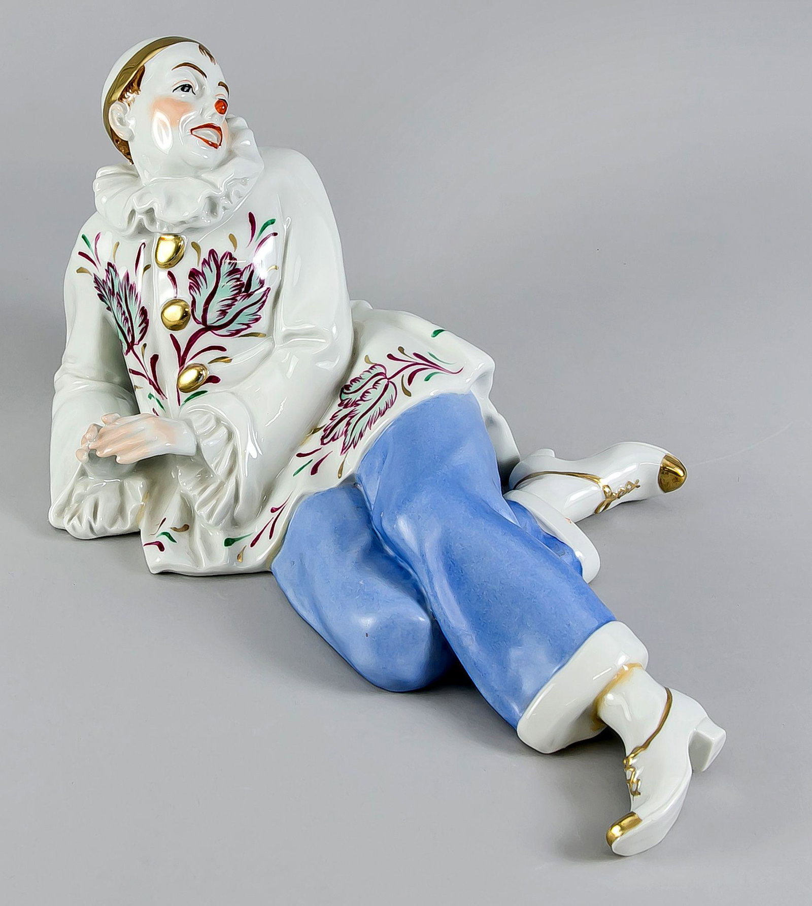 Reclining Pierrot, Ens, model numbe: Reclining Pierrot, Ens, model number 5052, onglaze stamp ''Muster'', polychrome painted, l. 39 cm