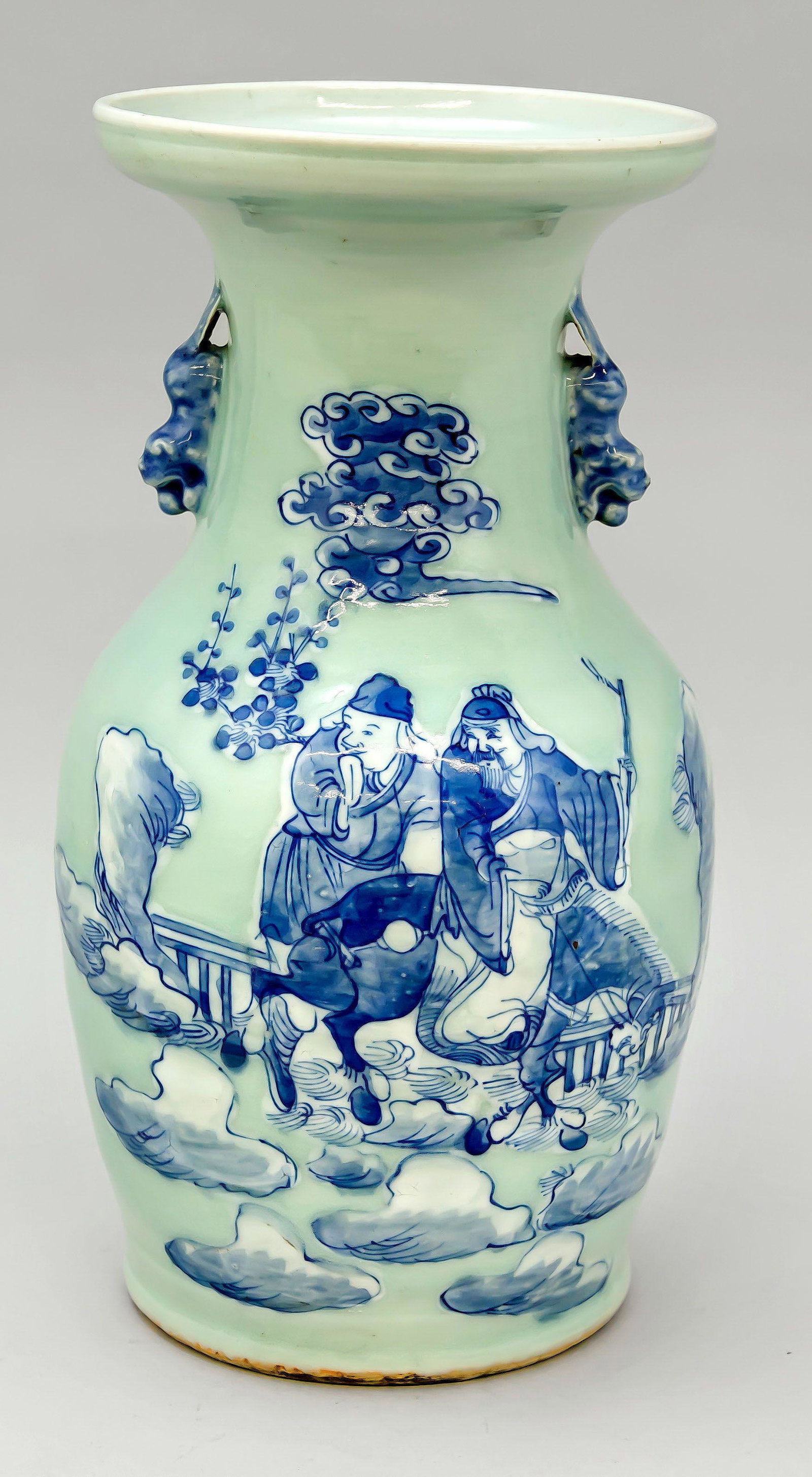 Seladon-ground vase with cobalt blu: Seladon-ground vase with cobalt blue decoration, China, 19th c., fo-lion handles on slightly indented neck, flared lip rim, slightly rubbed, h. 34 cm