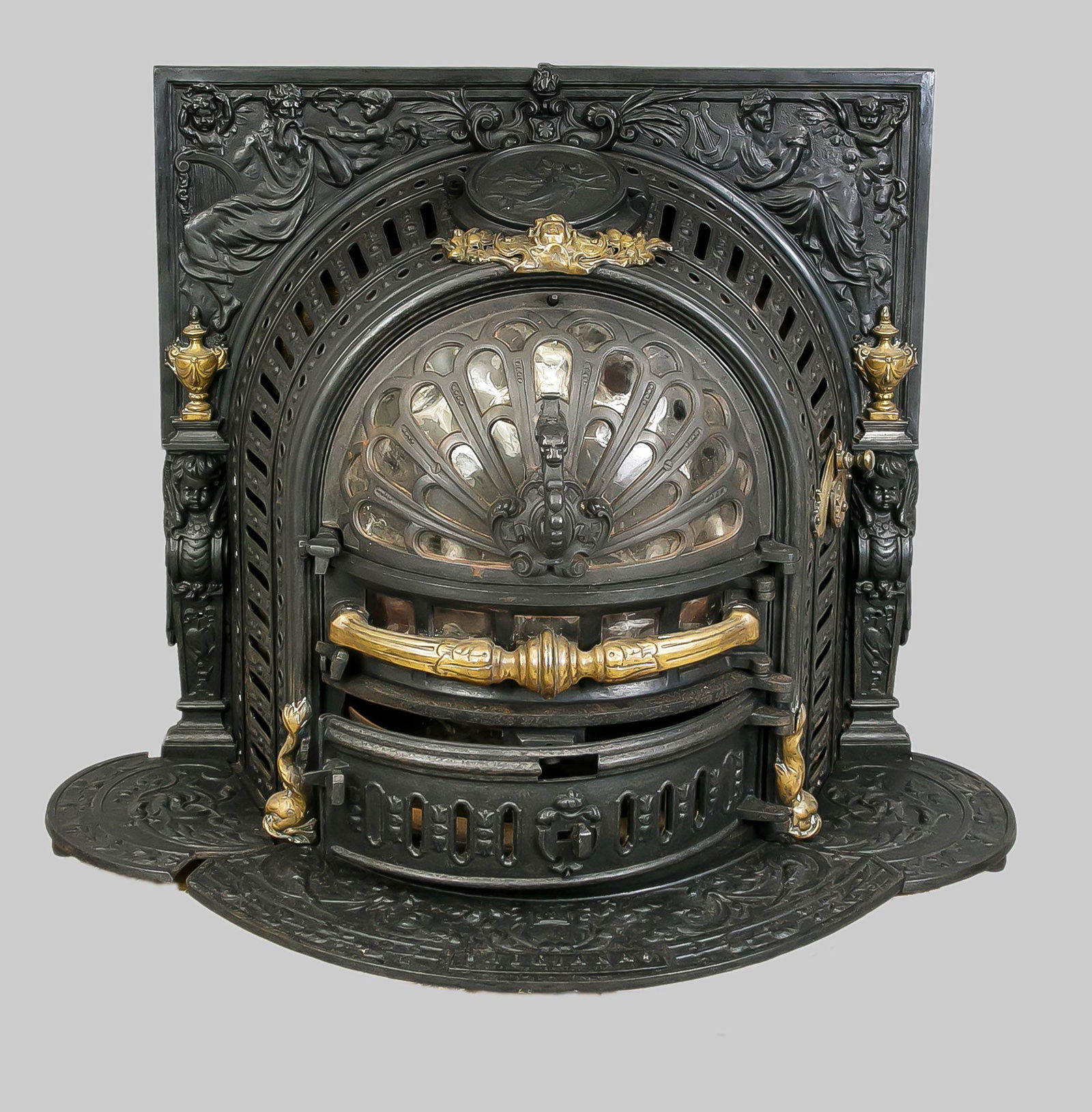 Fireplace insert with stove, late 1: Fireplace insert with stove, late 19th century, cast iron, brass. On the side marked ''E. M. Jaapsma, Amsterdam Sneek.'' Multiple openwork and ornamentation, lightly rubbed & bumped, approx. 75 x 75 x