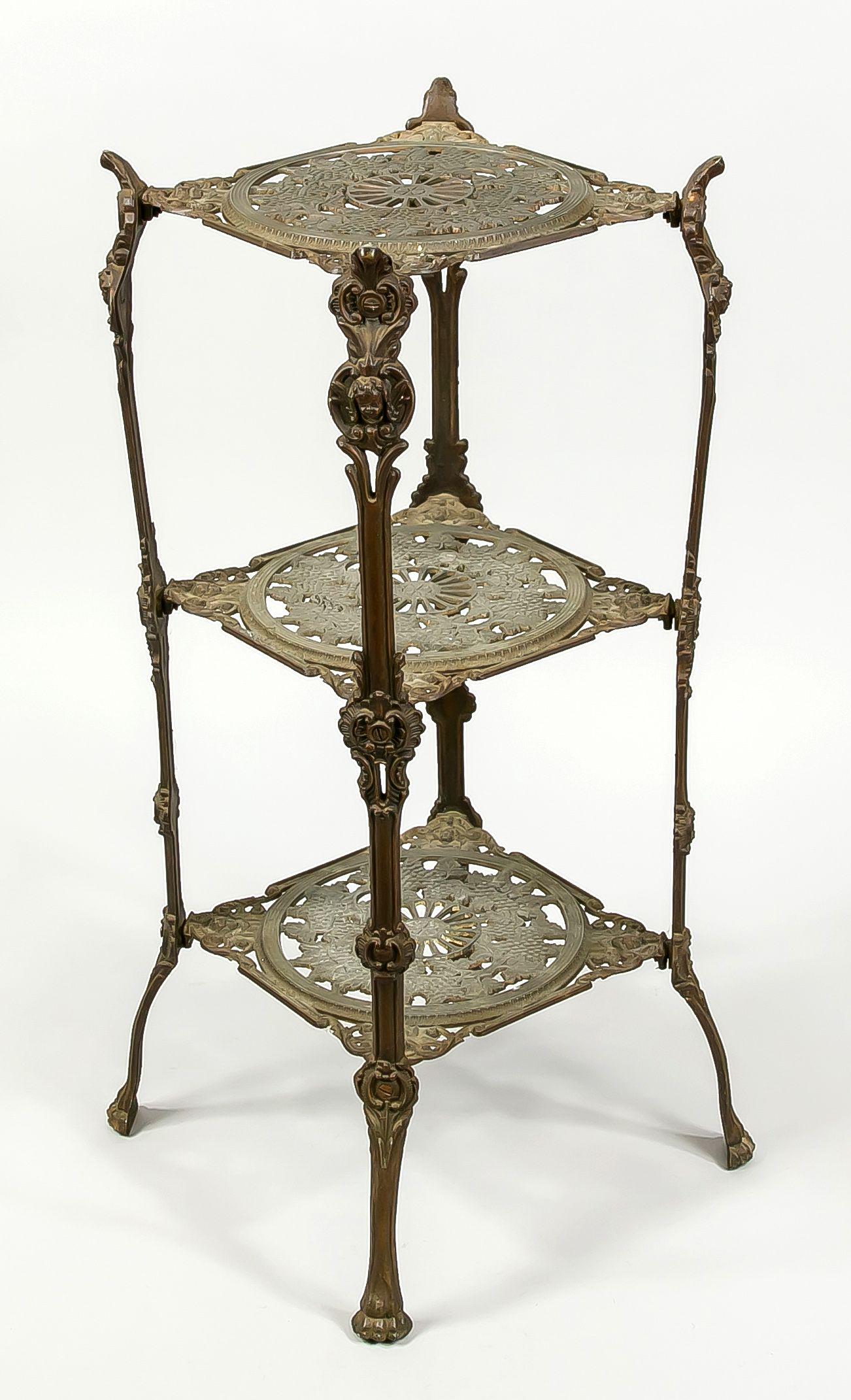 Side table/flower tray, late 19th c: Side table/flower tray, late 19th c., cast metal. 3 openwork ornamented tiers on 7 ornamented legs with paw feet, slightly rubbed, h. 72 cm.