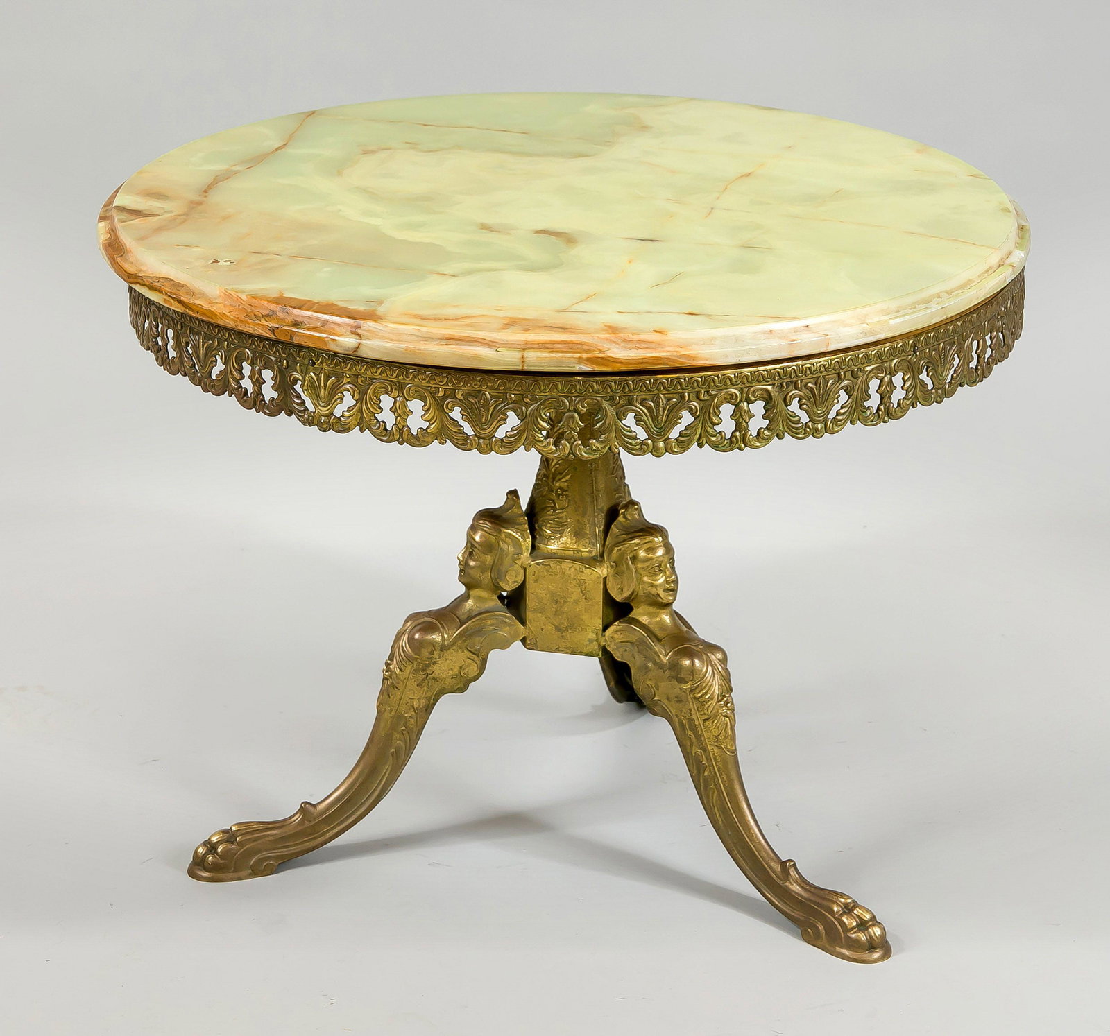 Low table, mid-20th c. Bronze base: Low table, mid-20th c. Bronze base with residual gilding on 3 feet, openwork gallery. Round top made of onyx. Slightly rubbed & bumped, h. 45/d. 58 cm.