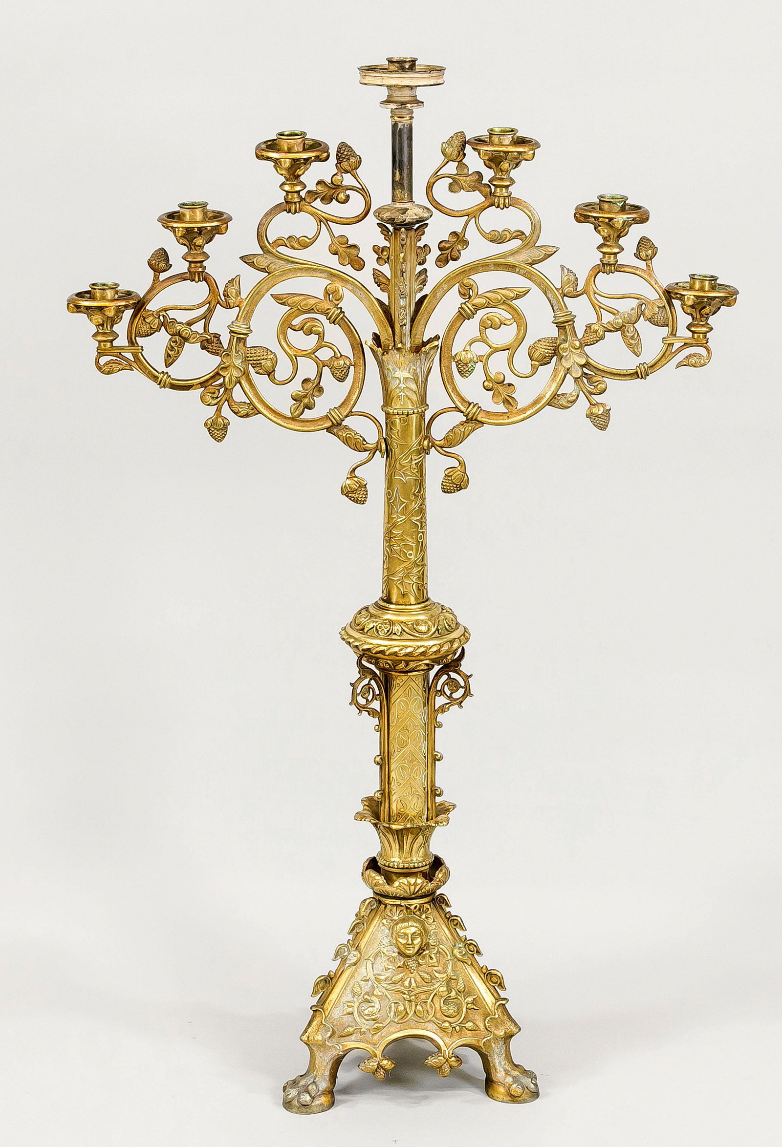 Large neo-gothic candelabrum, late: Large neo-gothic candelabrum, late 19th century, brass. Three-piece, heavily ornamented base on paw feet. Ornamented shaft with nodus, total 7 flames on openwork tendril. Slightly rubbed & bumped, h. 