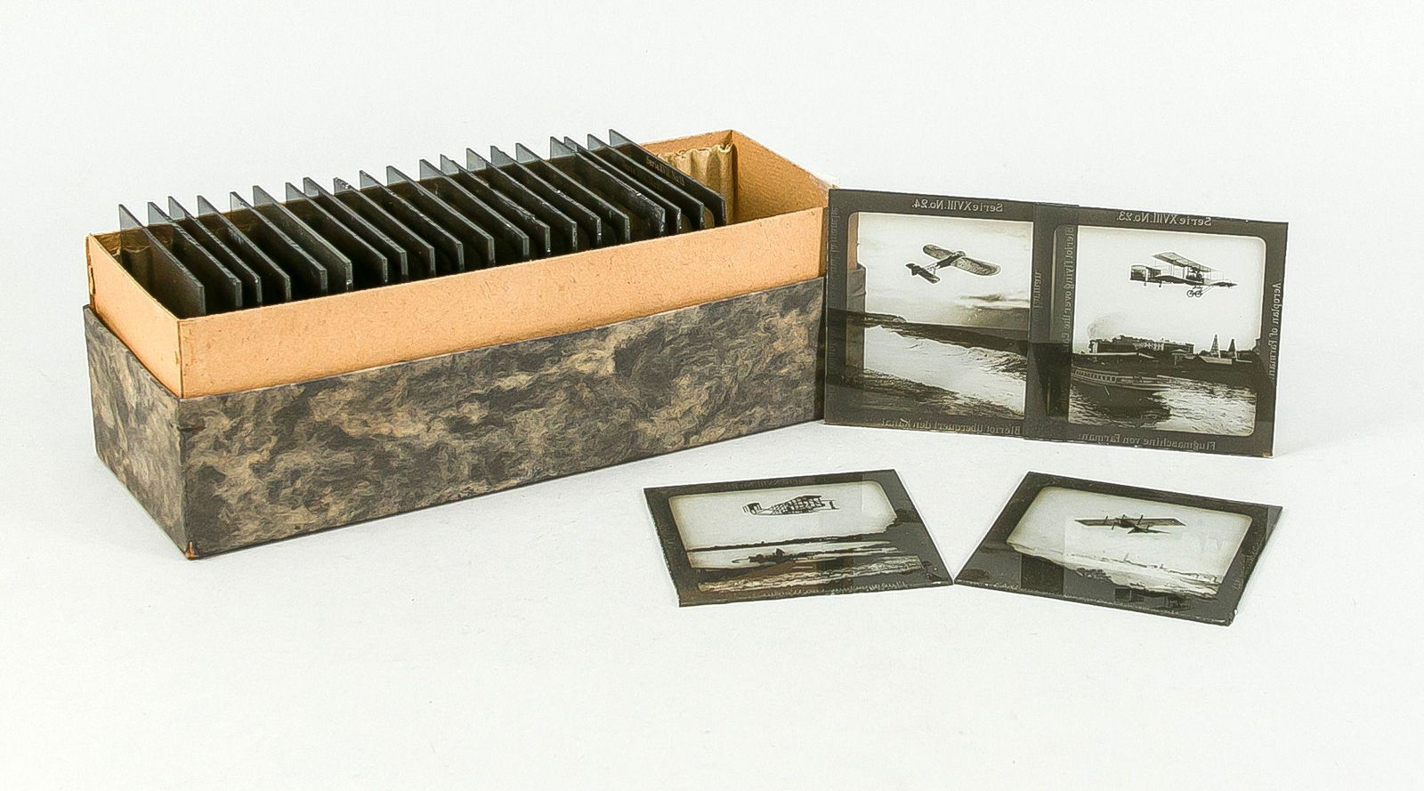 Glass pictures for projectors, arou: Glass pictures for projectors, around 1900, in original cardboard, with supplement: ''The Conquest of the Air (...) Projection Series 18''. In total 24 plates. slightly rubbed, dimensions cardboard 9
