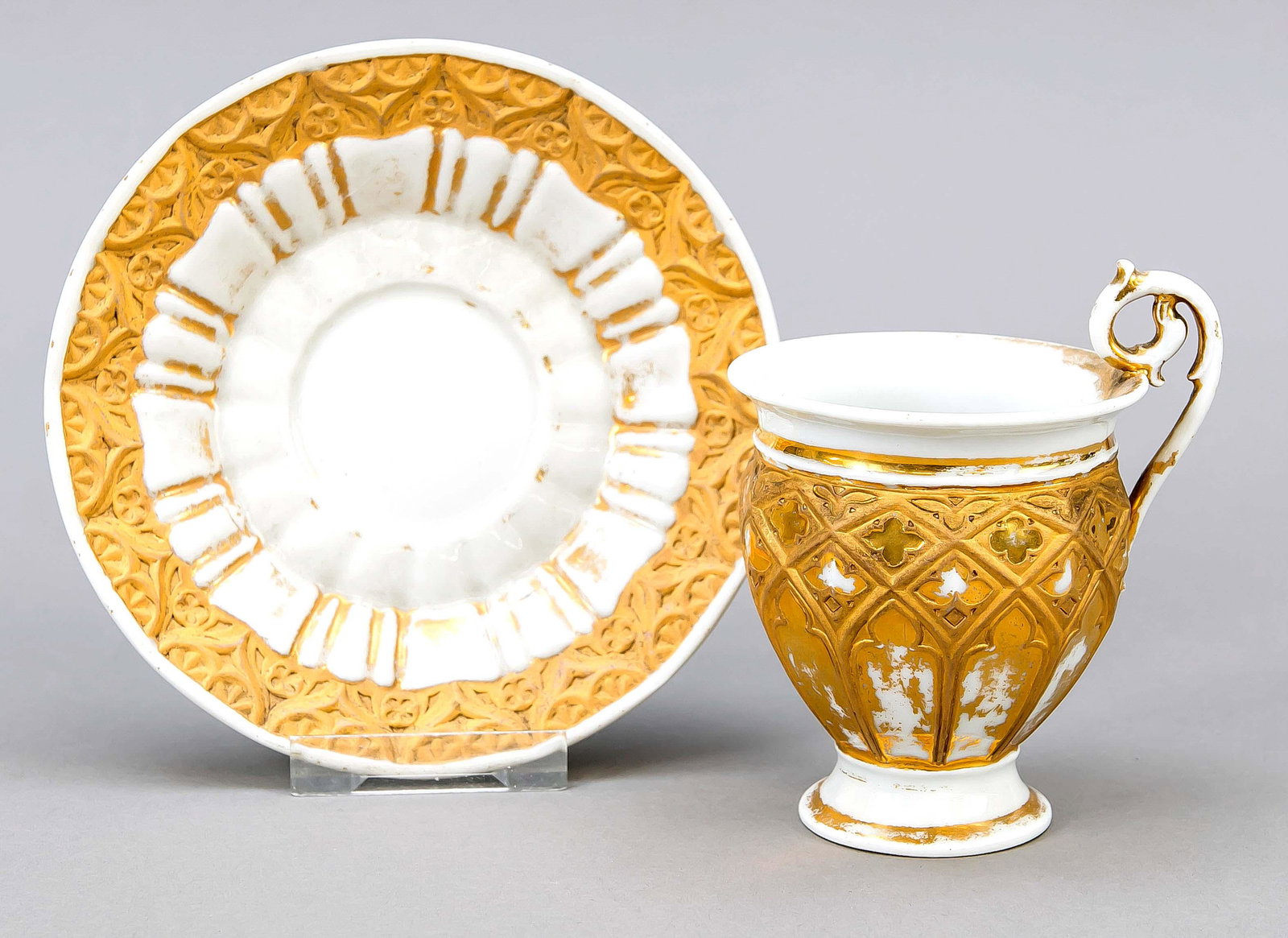 Point cup, Meissen, 19th centu: Point cup, Meissen, 19th century, bell-shaped with rosette handle, gothic ornaments in relief all around, gilding partly rubbed, h. 12 cm