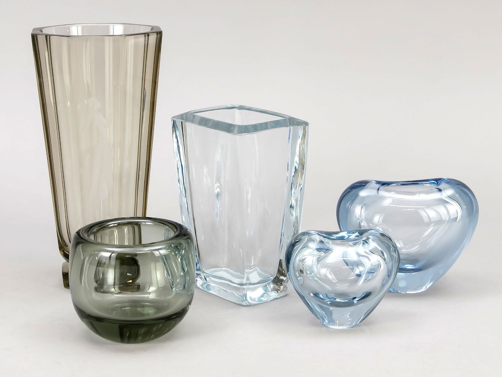 Five vases, Scandinavia, mainl: Five vases, Scandinavia, mainly Holmegaard, Denmark, different designers, various shapes and sizes, bluish, grey and brownish glass, partly edged, signed on the base, partly minimally bumped, h. up to