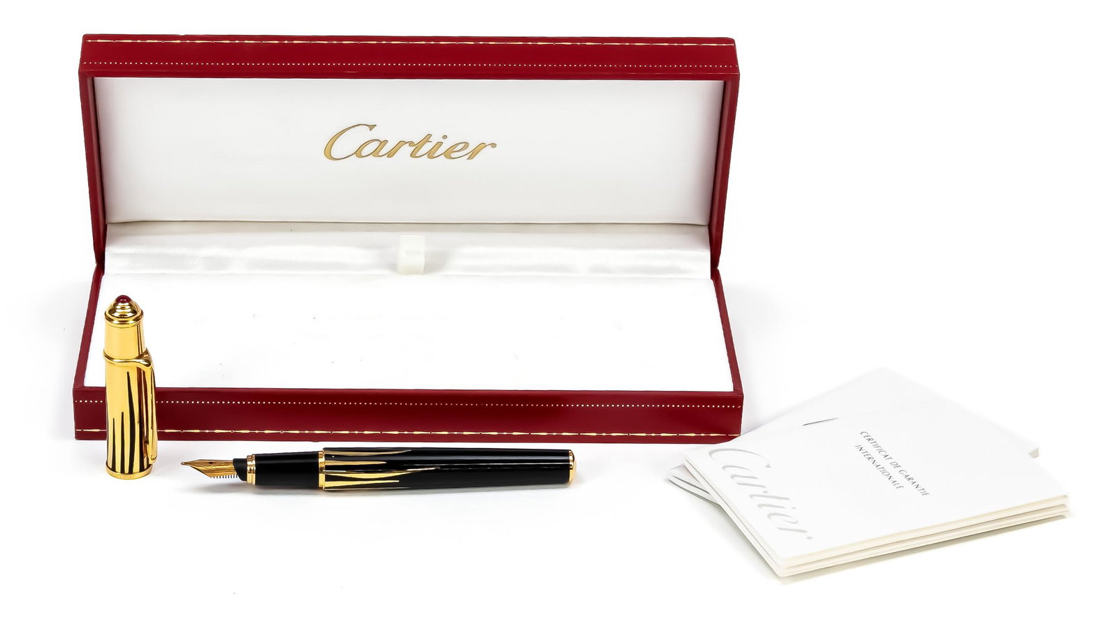 Cartier parton fountain pen, 2nd: Cartier parton fountain pen, 2nd half of the 20th century, 18K (750) yellow gold nib, black case with gilded applications, cap set with coloured stones, l. 11,7 cm, with 2 original cartridges, in orig