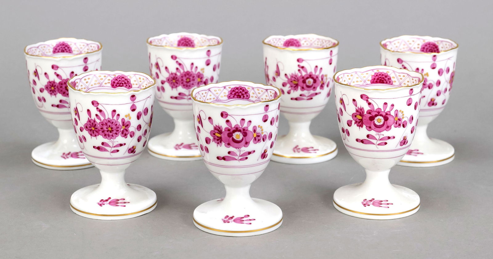 Seven egg cups, Meissen, end o: Seven egg cups, Meissen, end of 20th century, 1st choice, form New Cut, decor Indian Purple, ornamental gilding, 1x minimally bumped, h. 7 cm each