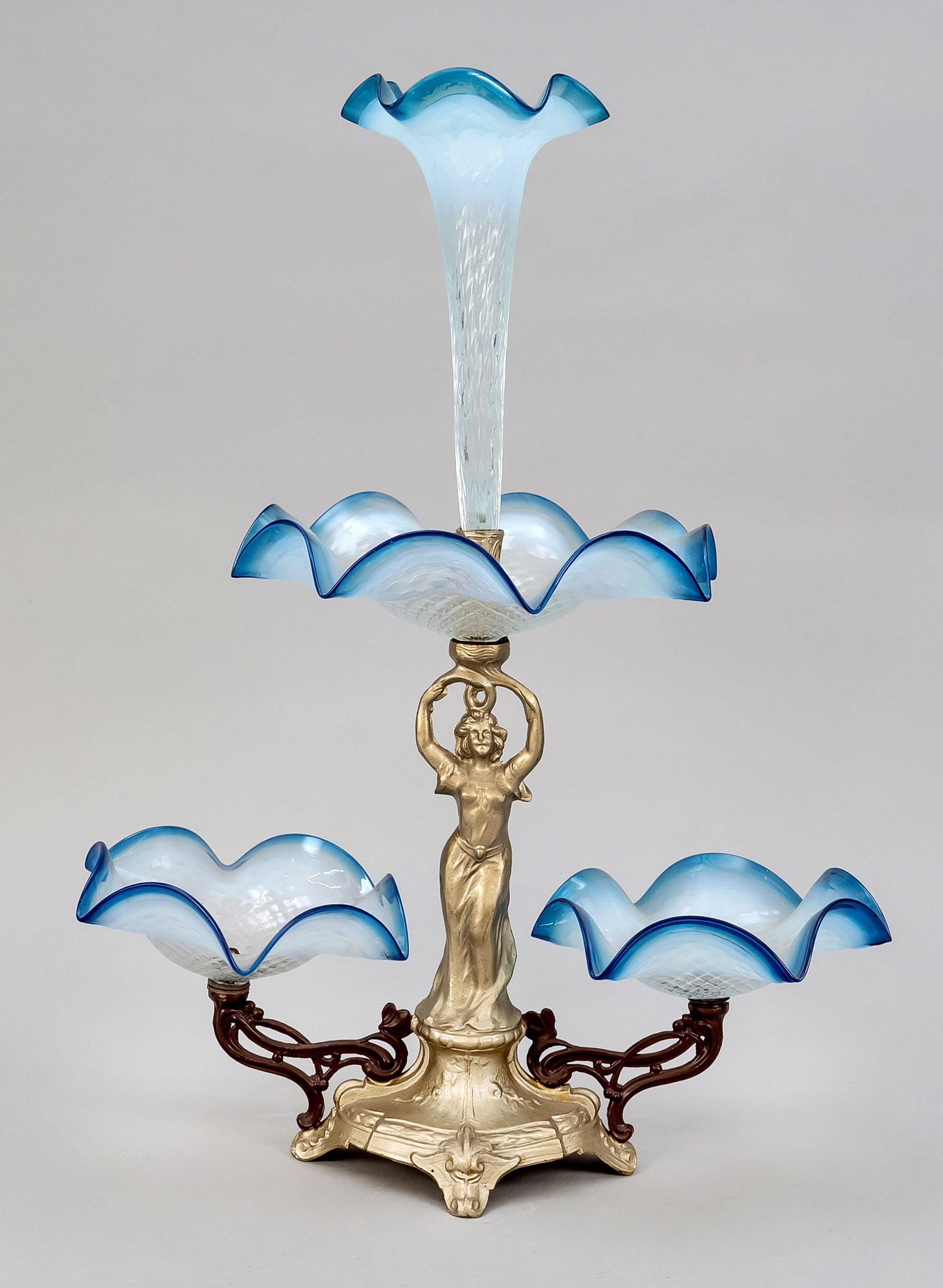 Centerpiece, early 20th centur: Centerpiece, early 20th century, cast metal and colored glass. Ornamented base on 4 feet with figural shaft, glass bowls in the shape of flowers, h. 56 cm.
