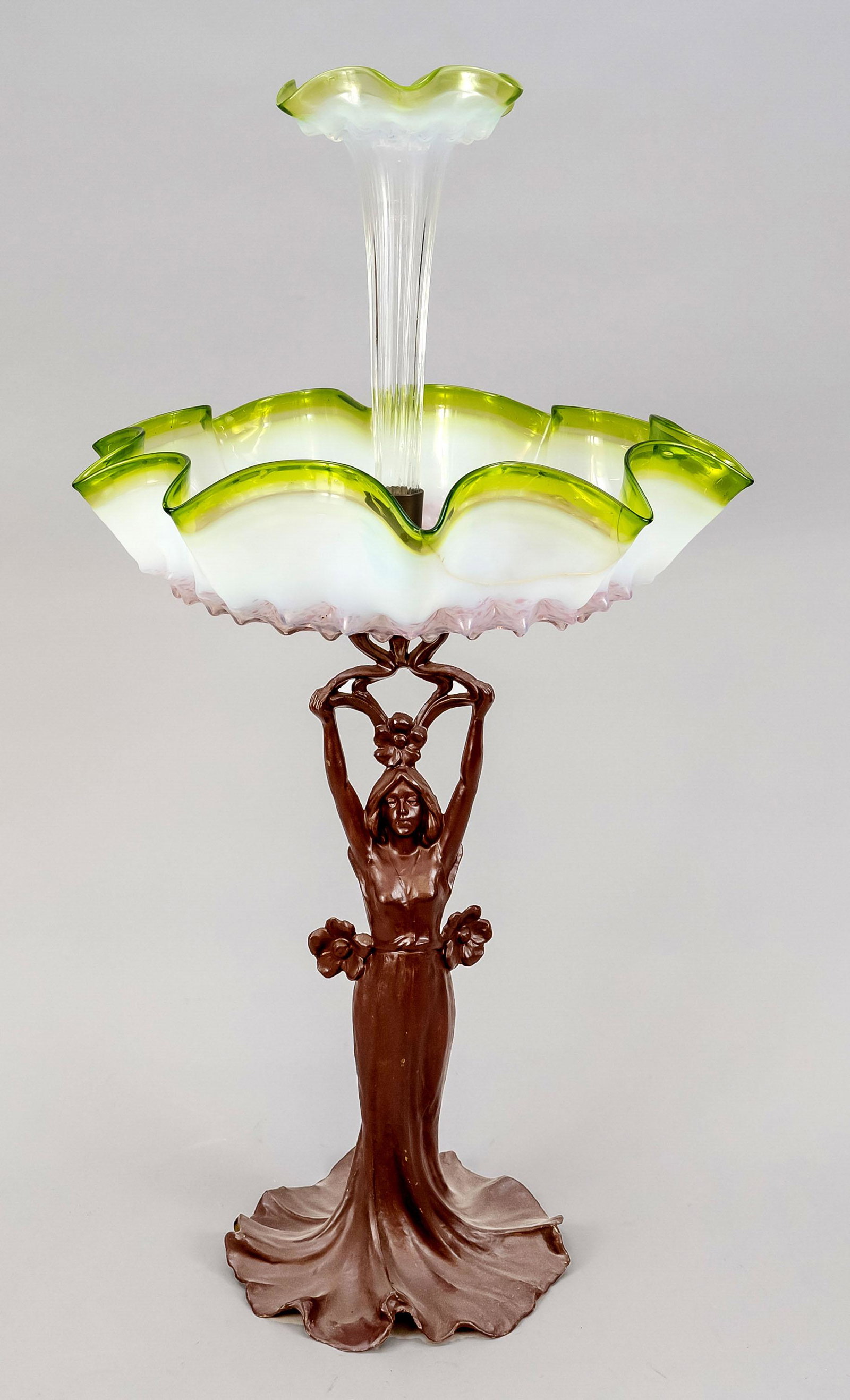 Centerpiece, early 20th centur: Centerpiece, early 20th century, bronzed metal casting and colored glass. Figural shaft, glass bowls in the shape of flowers, the large bowl glued in one place, h. 60 cm.