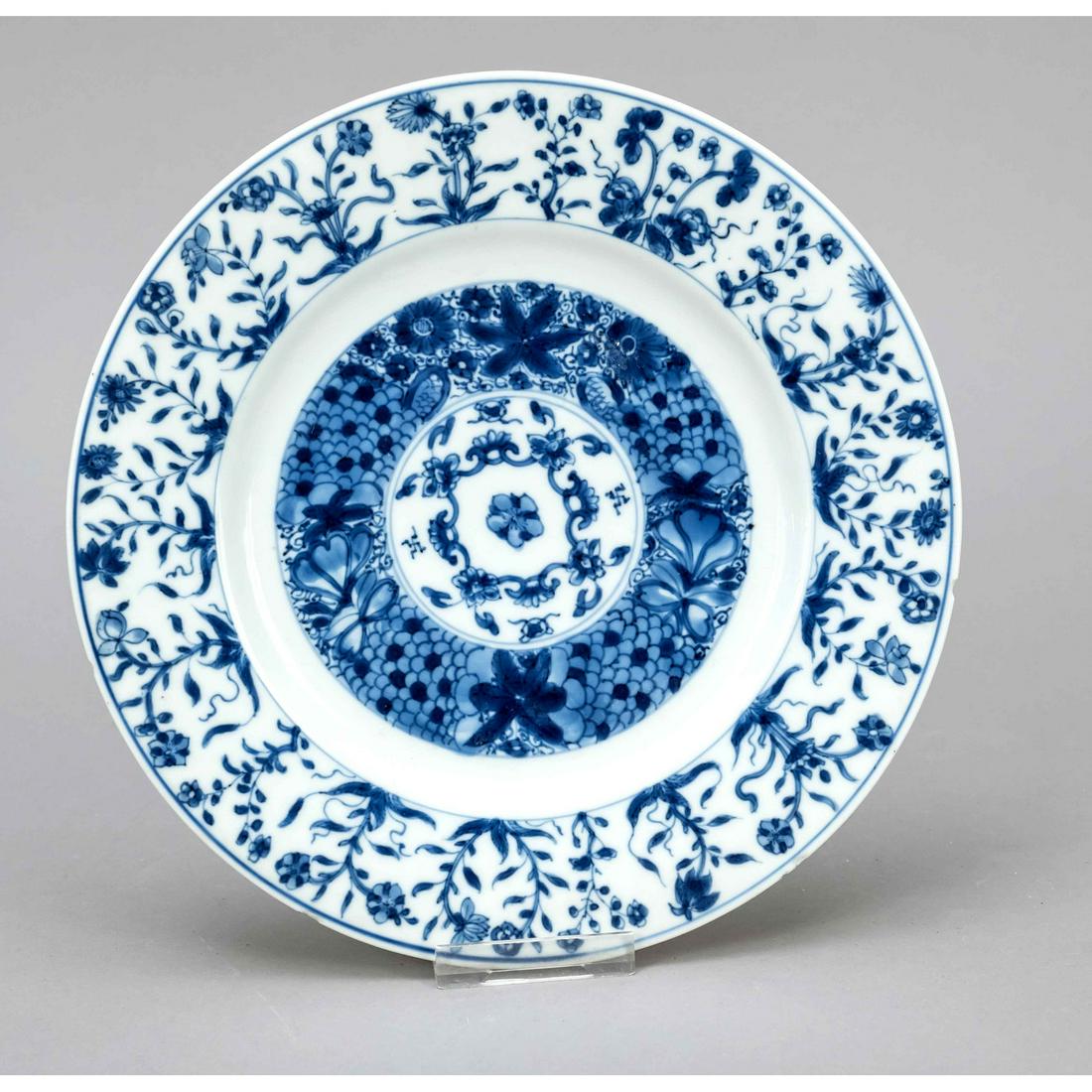 Blue and white plate, China, 1: Blue and white plate, China, 18th century (Kangxi/Qing). Cobalt blue floral dÃ©cor. Flag bottom with cobalt blue branches. Under the bottom a Kangxi picture mark in a double circle, lip rim with a s