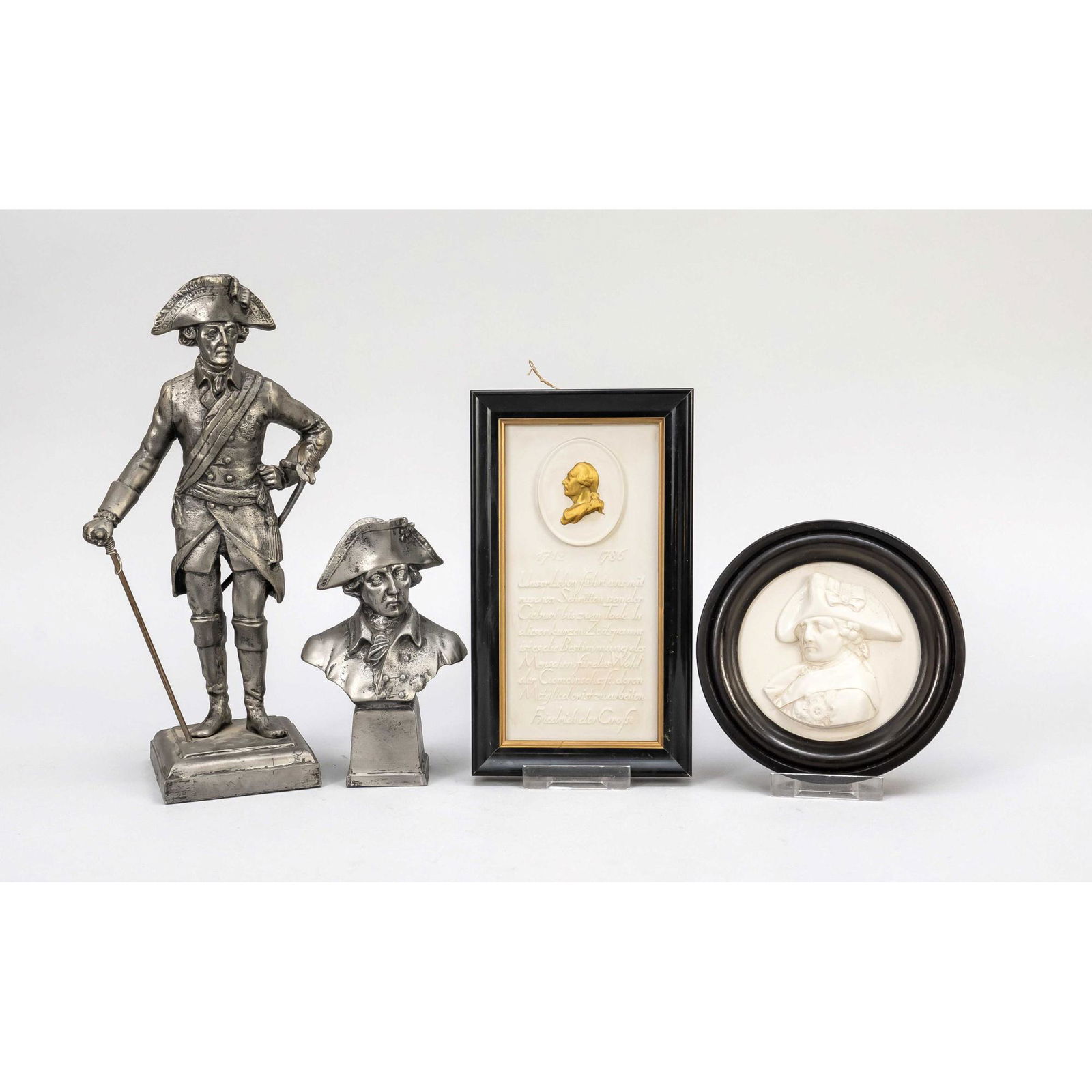 Convolute Frederick the Great, 4 p: Convolute Frederick the Great, 4 pieces. 2 bisque plaques, 1 round, 1 rectangular with quotation of Frederick. 1 small bust on base, 1 statuette. 20th century, both pewter castings. H. to 28 cm.