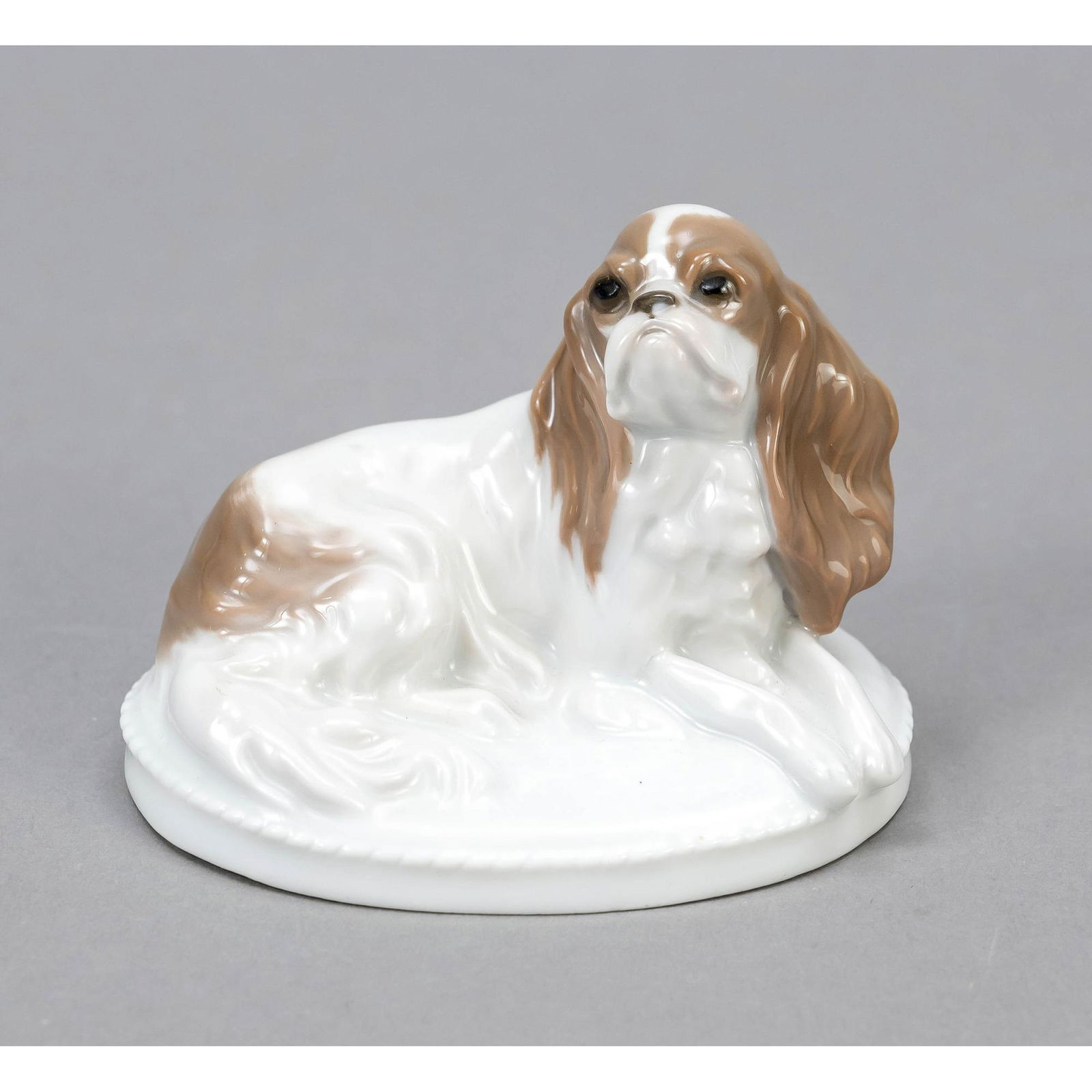Small 'King Charles dog', Rosenthal,: Small 'King Charles dog', Rosenthal, Selb-Bavaria, 1928, designed by Fritz Diller in 1913, signed, model no. K289, naturalistic painted in underglaze colours, on oval base with beaded rim, w. 8 cm