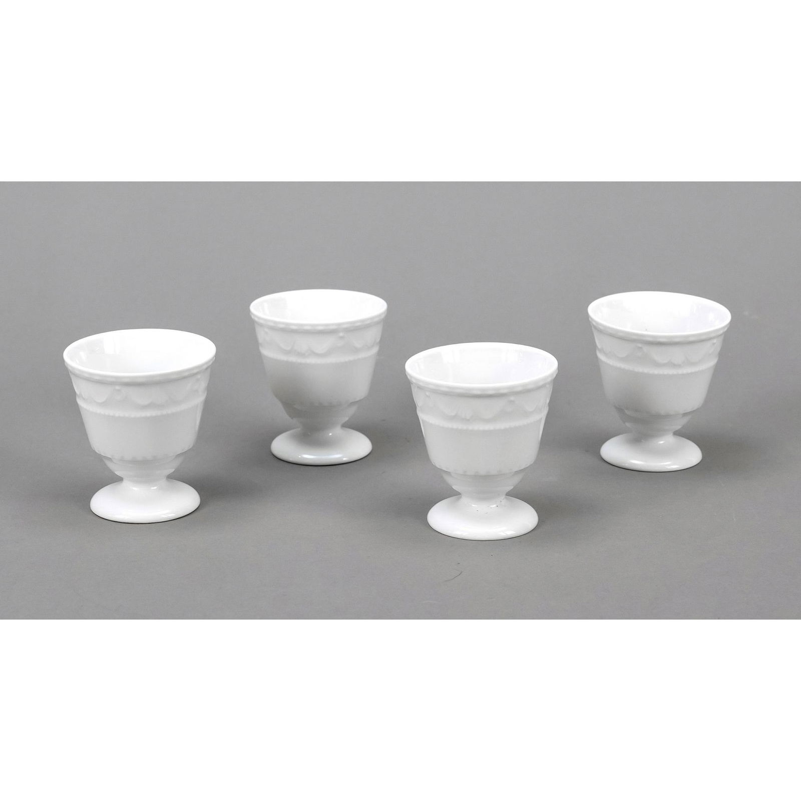 Four egg cups, KPM Berlin, 2nd half: Four egg cups, KPM Berlin, 2nd half of the 20th century, 1st choice, form Kurland, design for the last Duke of Kurland around 1790 by Friedrich Elias Meyer, white, h. 6 cm