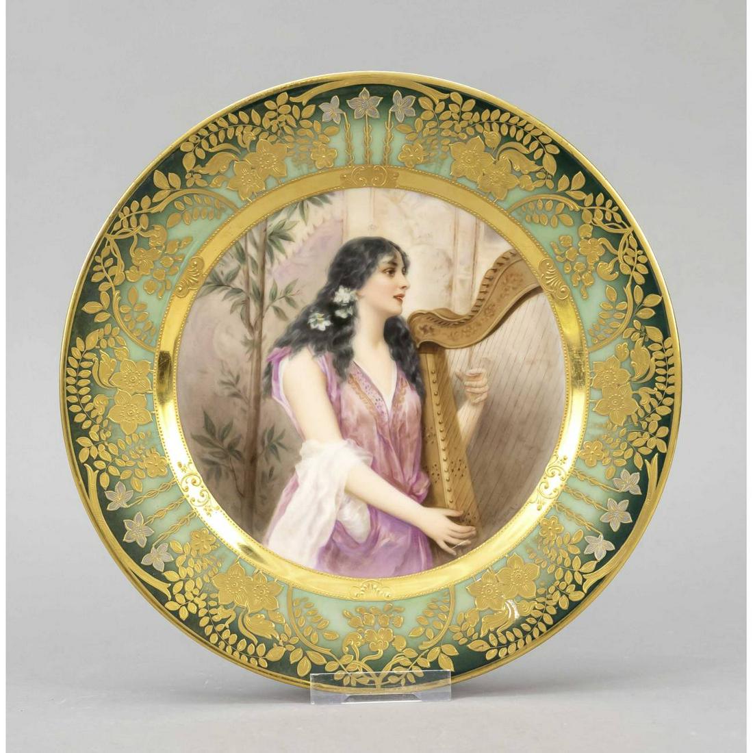 Plate, Thuringia, 20th century, t: Plate, Thuringia, 20th century, the mirror decorated with fine polychrome painting depicting a harpist, signed Wagner on the right, verso inscribed 'Festgesang', rich gold decoration on green backgrou