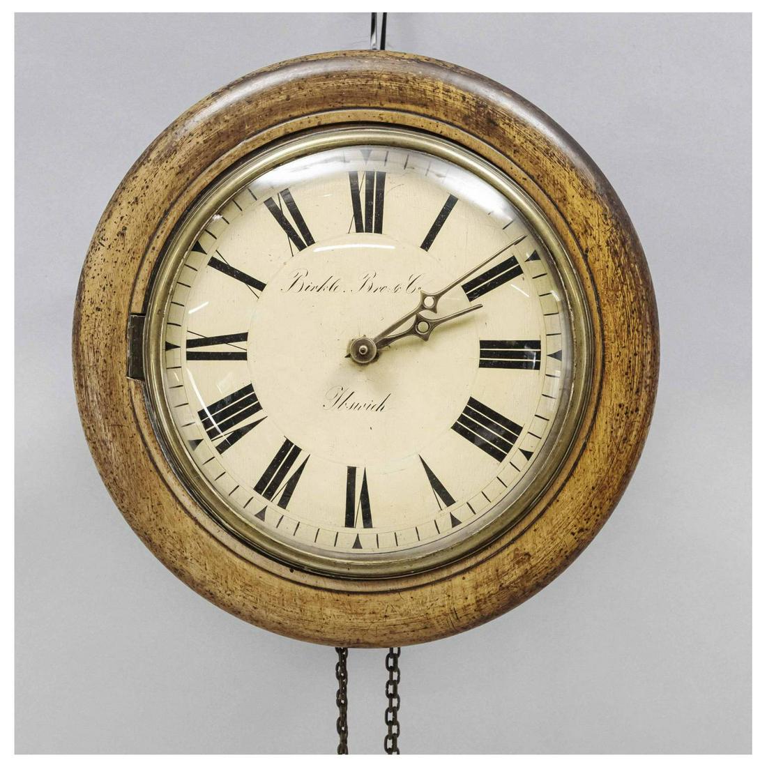 Wooden wall clock, marked ''Birkle: Wooden wall clock, marked ''Birkle Bro. & Co. Ibswich'', round case, sand colored dial with black roman numerals, brass hands, domed glass in gilded glass rim, wooden stand movement with 1/2 hour stri