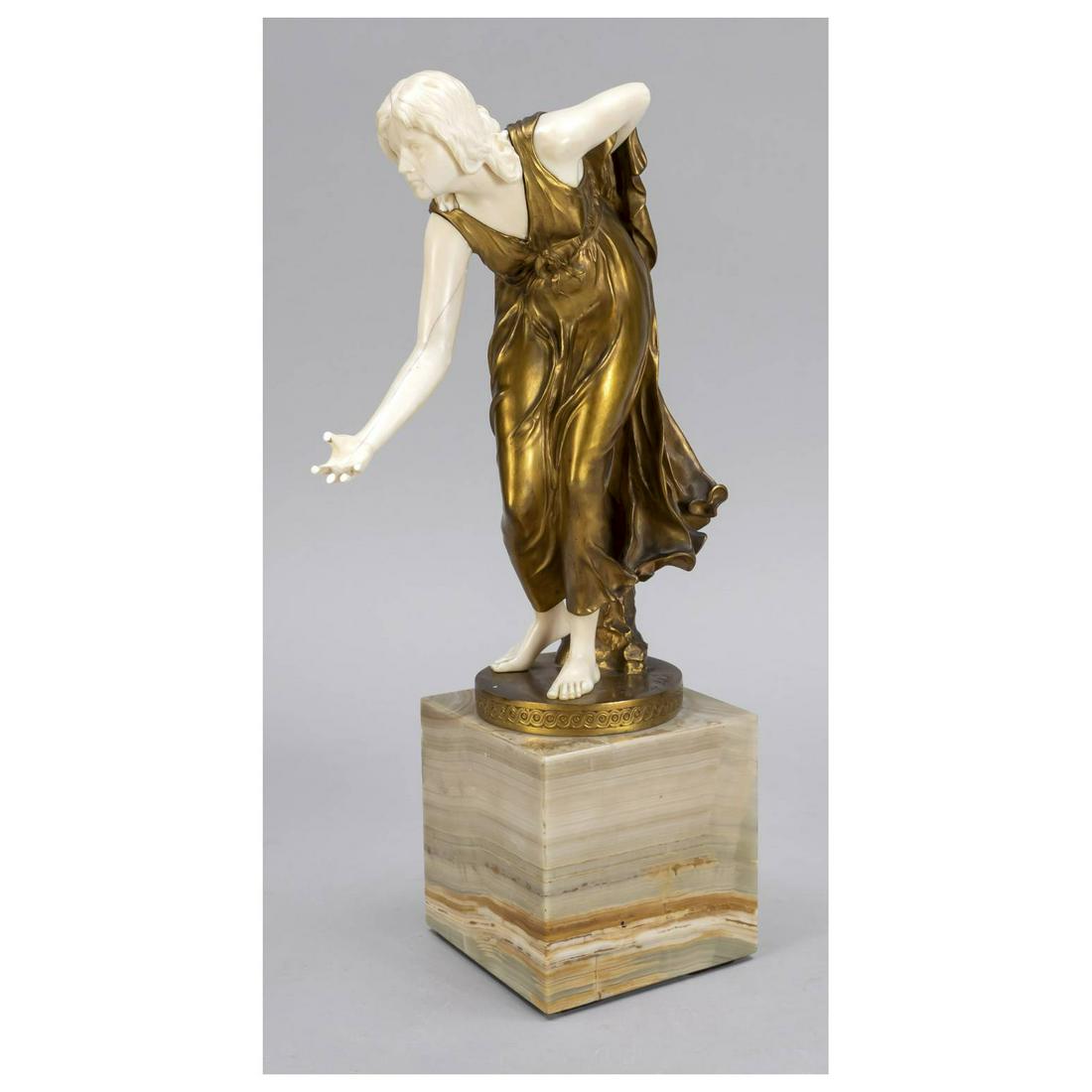 Walter Schott (1861-1938), female b: Walter Schott (1861-1938), female ball player, chryselephantine figure, gold patinated bronze and bone over onyx marble cube, signed in the stand and foundry mark of Gladenbeck, ball missing, finger o