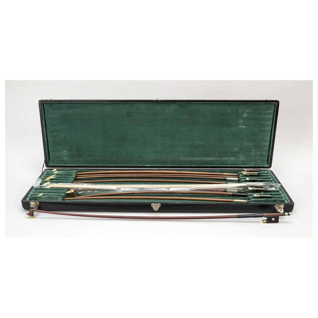 9 violin bows in box, 19th/20th ce: 9 violin bows in box, 19th/20th century, 4 of them signed (partly illegible). All with frog mounting and winding. All except one without stringing, l. from 65 to 75 cm. Flat black box for a total of 1
