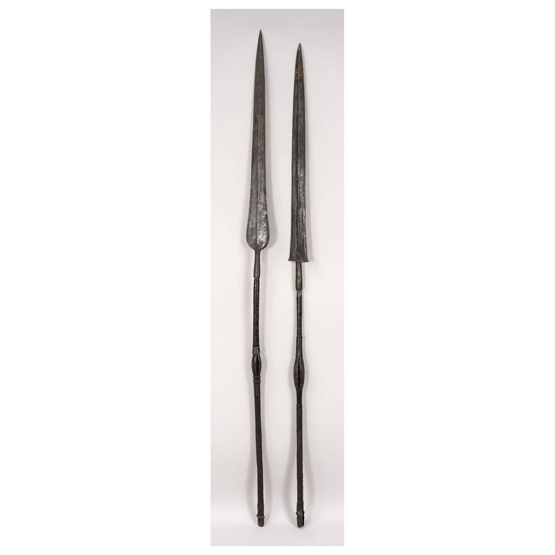 2 spears, Africa, exact age unknow: 2 spears, Africa, exact age unknown. carved wooden shafts with winding, attached iron spearheads, l. 151 & 155 cm.
