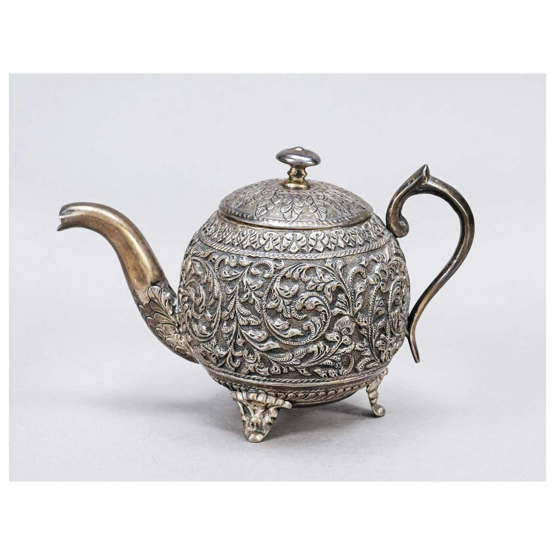 Jug, Asia, 20th century, Siber tested: Jug, Asia, 20th century, Siber tested, on 3 feet, spherical body, lateral attached curved handle, wall with rich relief decoration, floral and ornamental motifs, h. 11 cm, ca. 400 g