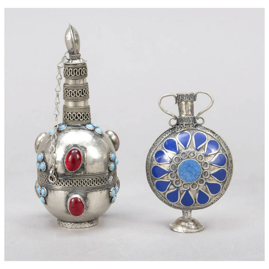 Two flasks, probably Caucasian, 20th: Two flasks, probably Caucasian, 20th c., plated, different shapes and sizes, 1x with blue enamel and color stone set, 1x with turquoise and glass stone set, h. to 12 cm.