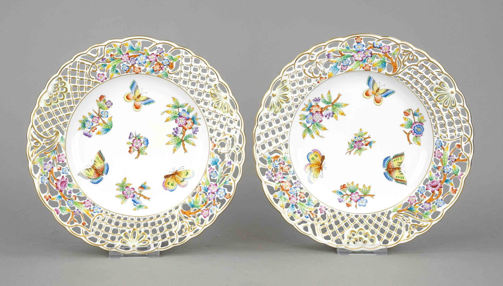 Pair of breakthrough plates, Her: Pair of breakthrough plates, Herend, Hungary, 20th century, curved form, openwork flag with wickerwork, trelliswork and floral decor, Victoria decor, polychrome painting with blossom branches and butt
