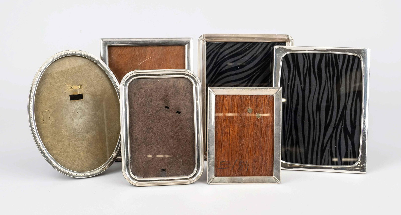 Six photo standing frames, 20th: Six photo standing frames, 20th century, different makers, 5x silver different finenesses or tested, 1x plated, different shapes, medium sizes, partly damaged, total dimensions up to 20,5 x 15,5 cm