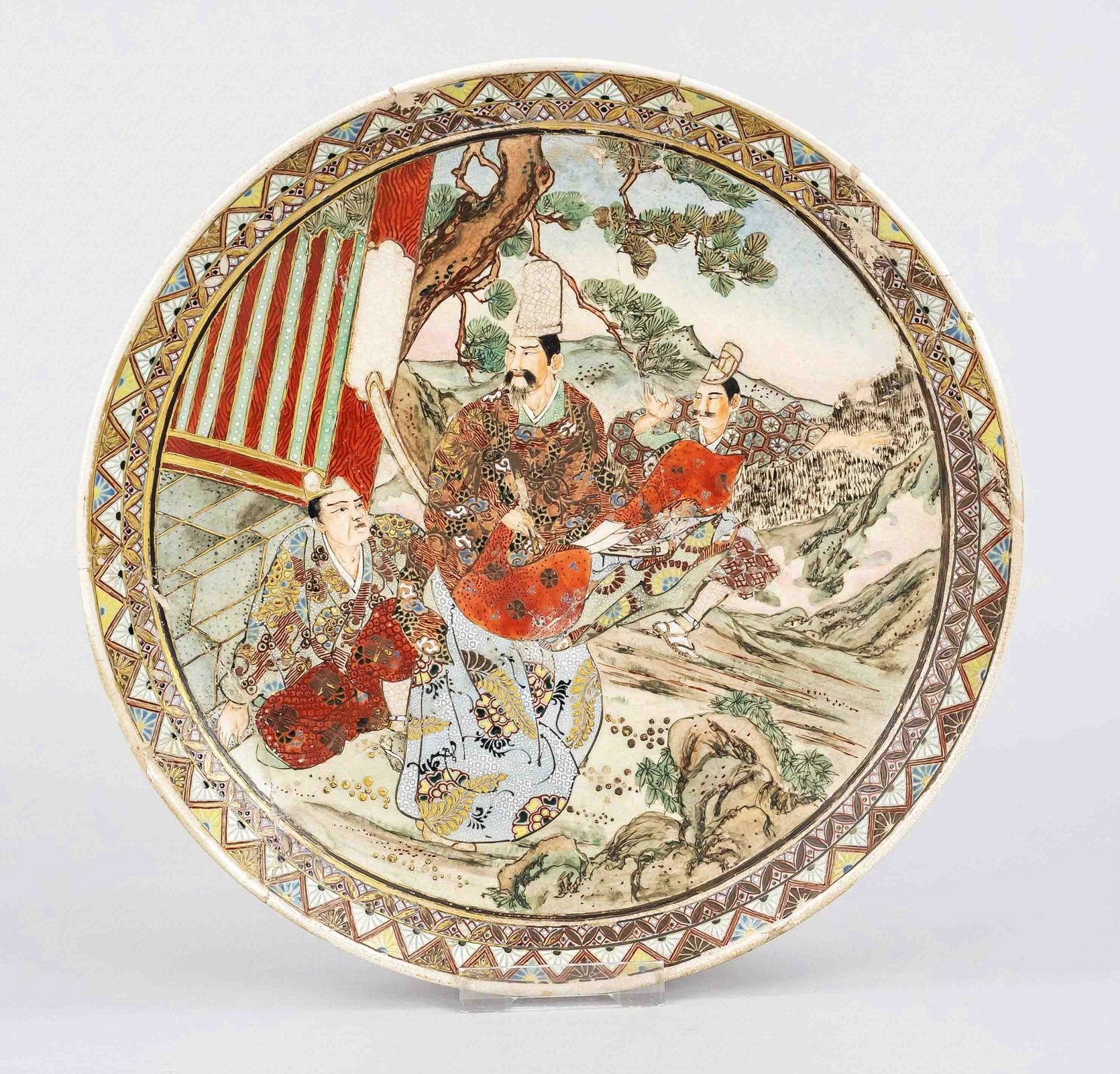 Satsuma plate, Japan, Meiji pe: Satsuma plate, Japan, Meiji period(1868-1912) c. 1900, ivory porcelain with polychrome enamel decoration en relief(jap. moriage) of samurai under pine tree, gold highlights, restored, d 24,5cm