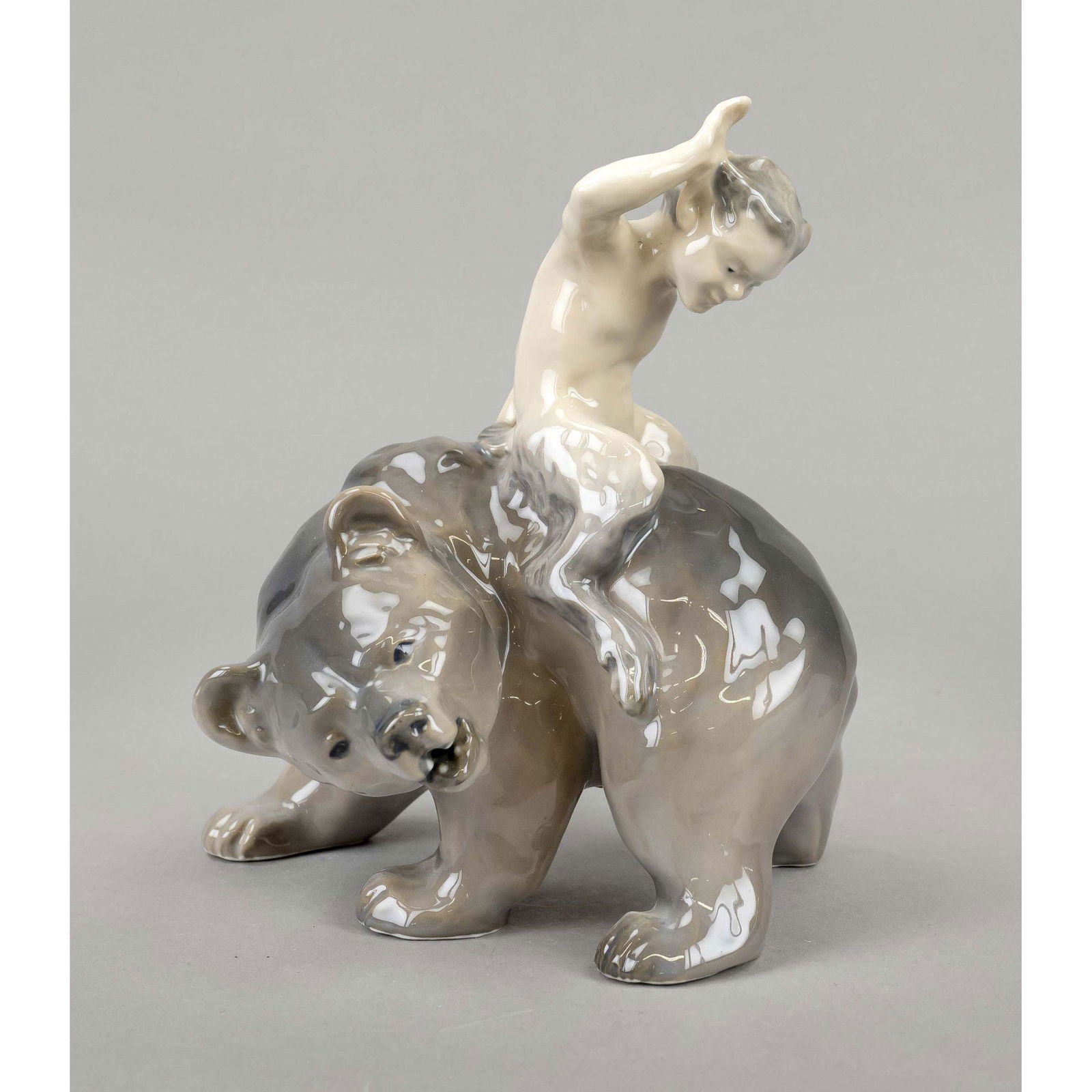 Faun riding backwards on a bea: Faun riding backwards on a bear, Royal Copenhagen, before 1923, designed by Knud Kyhn (1880 - 1969), model no. 976, polychrome painted in underglaze colors, h. 20 cm