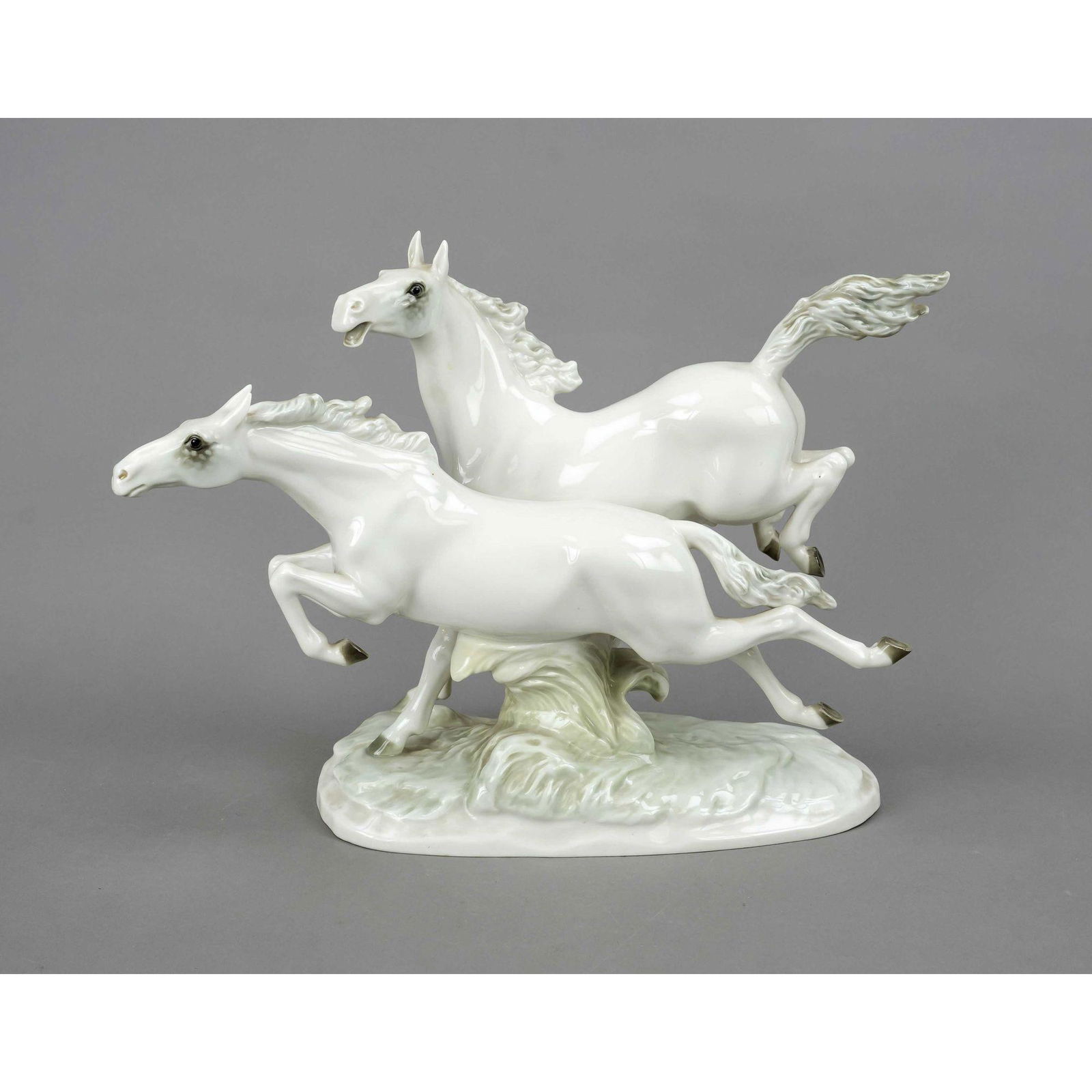 In freedom, Hutschenreuther, S: In freedom, Hutschenreuther, Selb, mark of art department 1955-69, design M.H.Fritz, galloping pair of white horses, polychrome painted in naturalistic underglaze colors, oval terrain base, 30 x 40 x