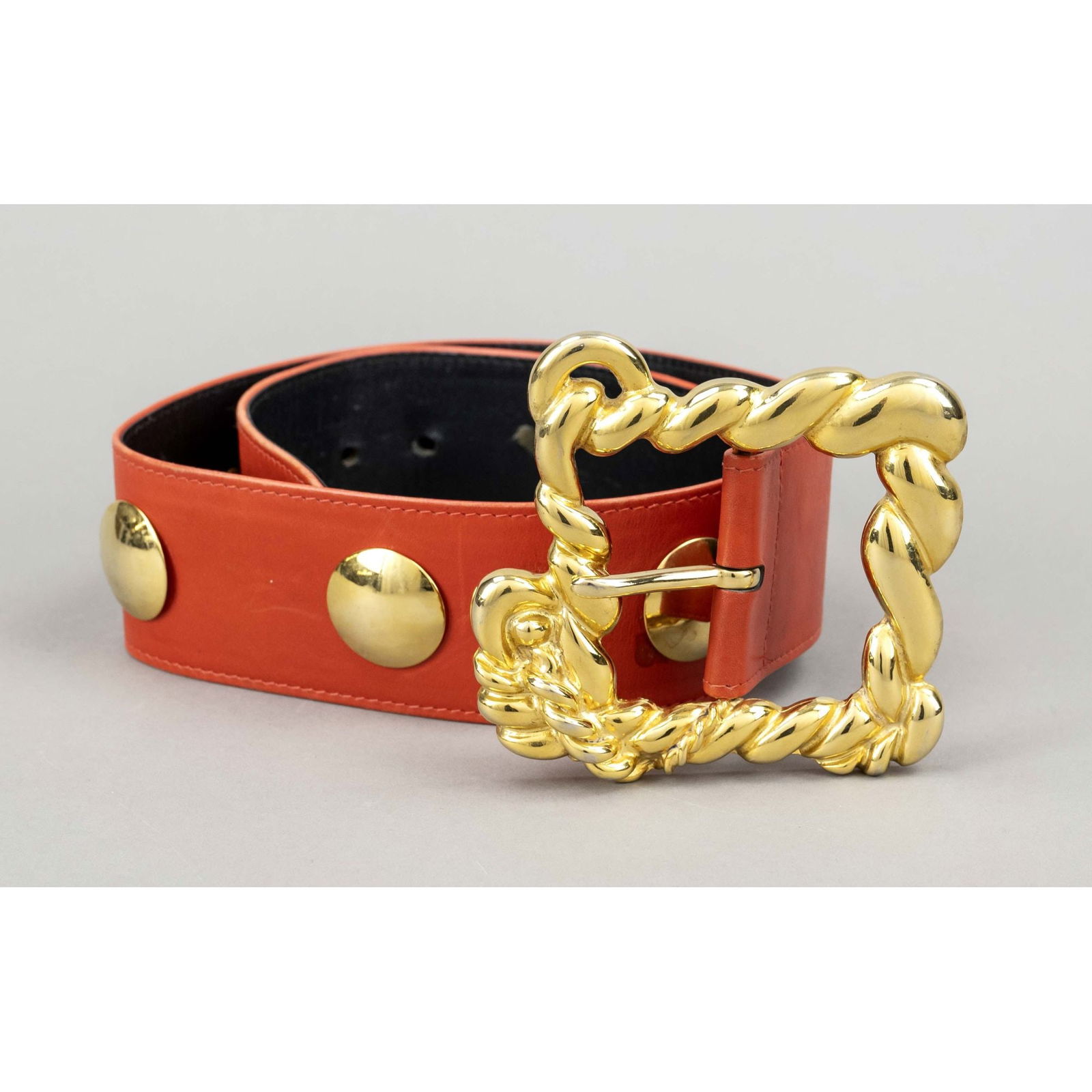 Escada, wide waist belt, orange-re: Escada, wide waist belt, orange-red leather with partial studding, large gold-tone buckle in the shape of intertwined ropes, slight signs of wear and storage, min, stained, l. approx. 184, w. approx.
