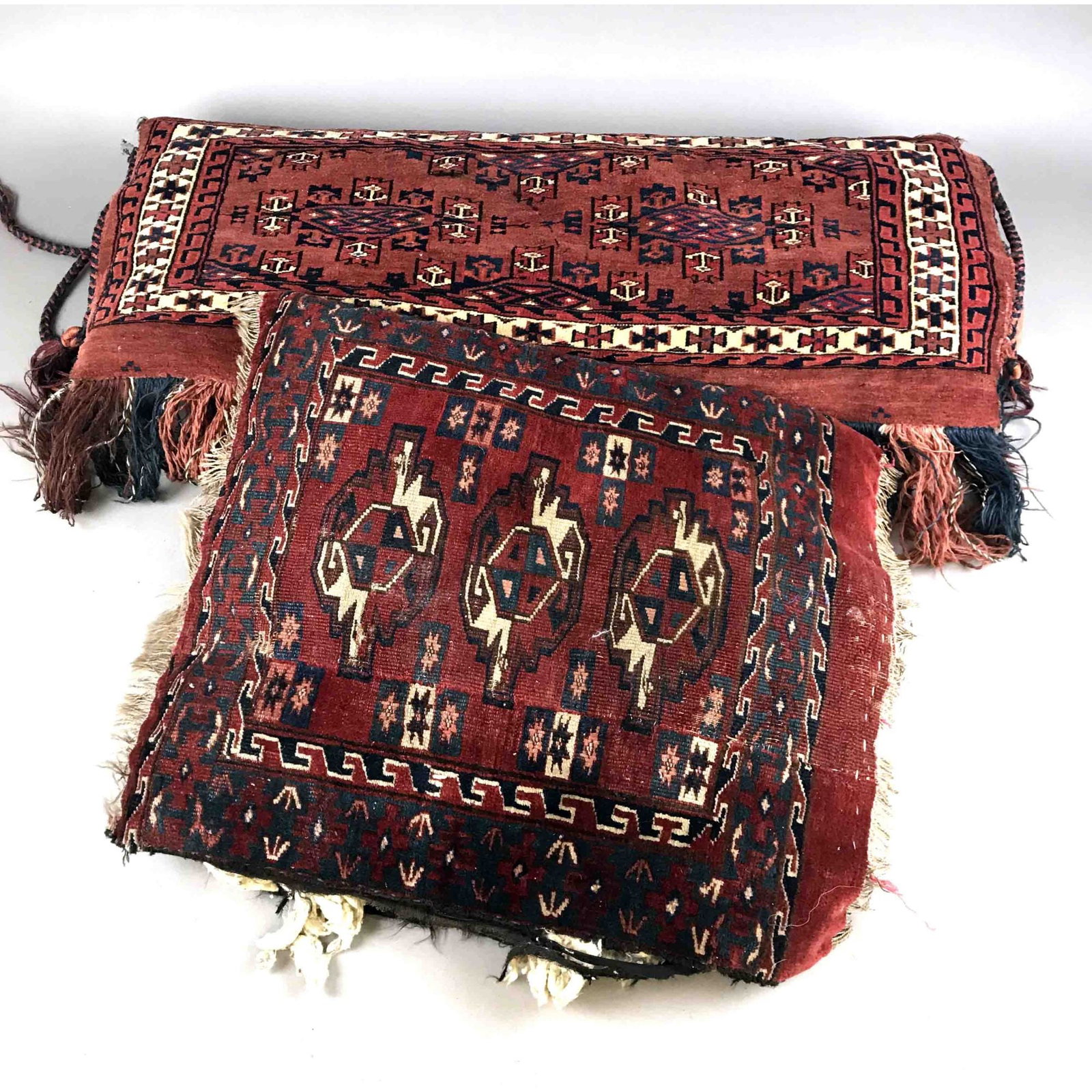 1 Chuval Turkmen mounted as cushi: 1 Chuval Turkmen mounted as cushion, 1 Turkmen carpet fragment mounted as cushion. traces of use, up to 94 x 37 cm
