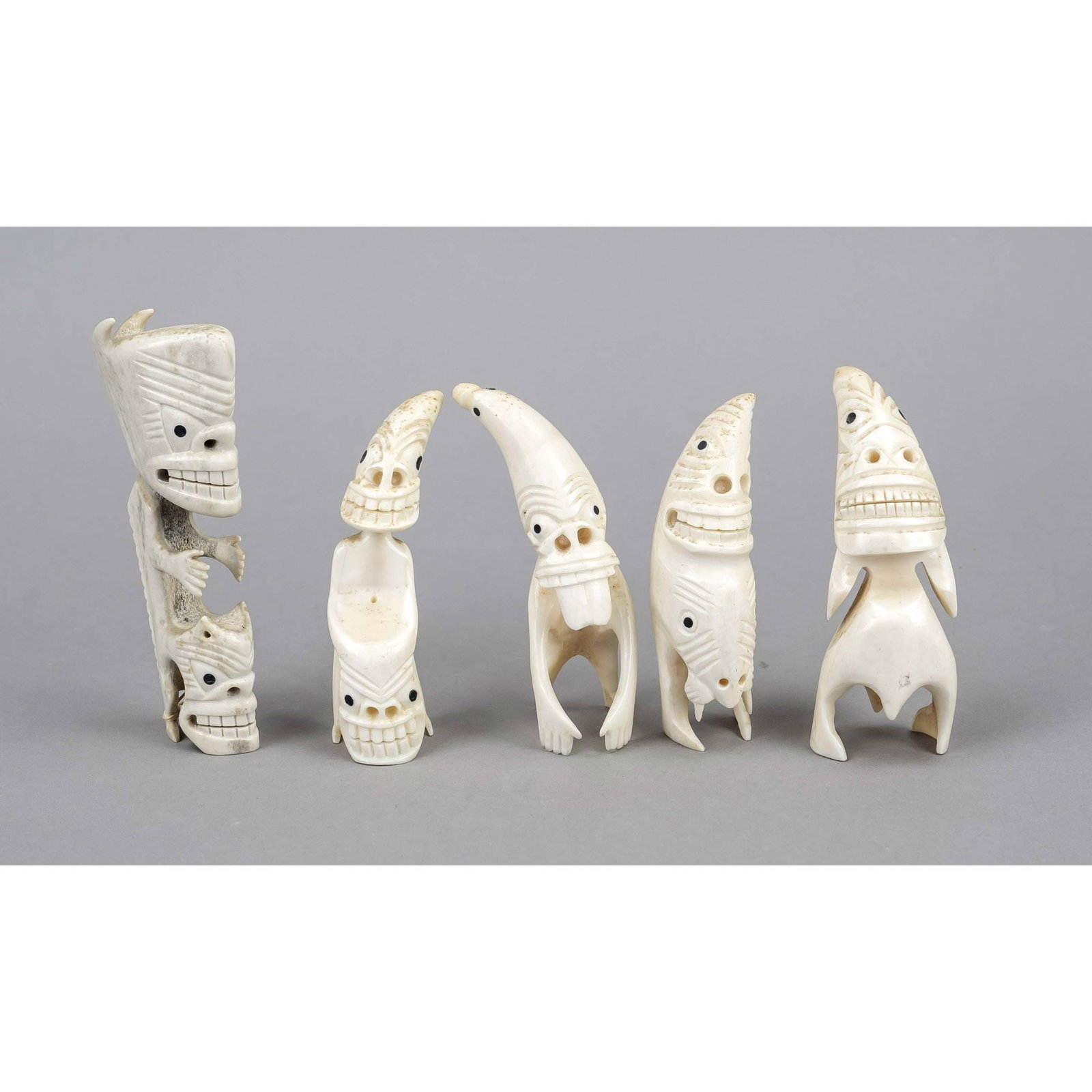 5 Tupilak, Greenland, 20th centu: 5 Tupilak, Greenland, 20th century, carved walrus tusk. Figural with grimaces, rubbed, h. up to 13 cm