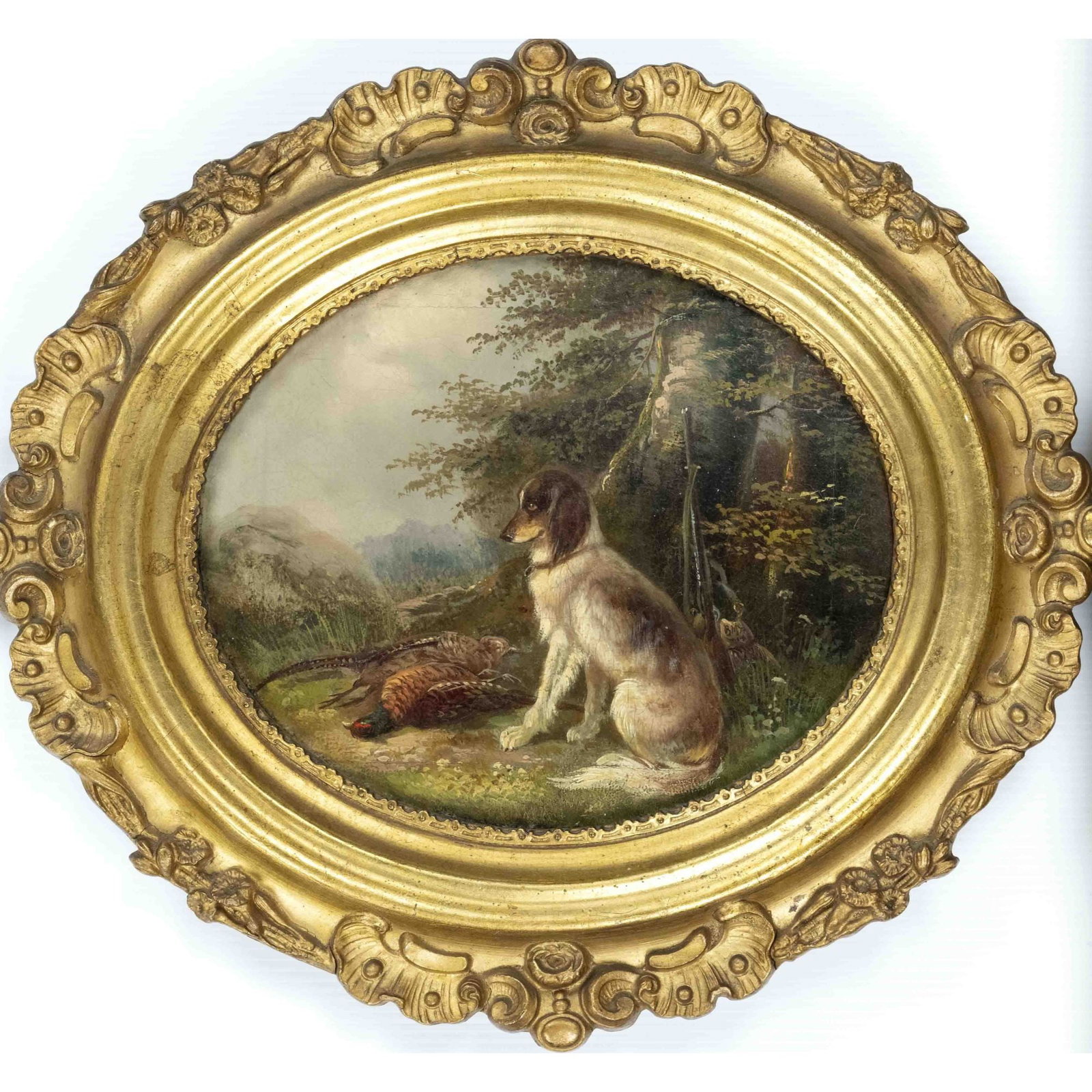 Monogramist B.M., 19th century: Monogramist B.M., 19th century hunting painter, oval landscape with sitting hunting dog in front of shot pheasants and mounted rifle, monogrammed and dated ''B.M. 77'' at the side of the dog, 17 x 20 