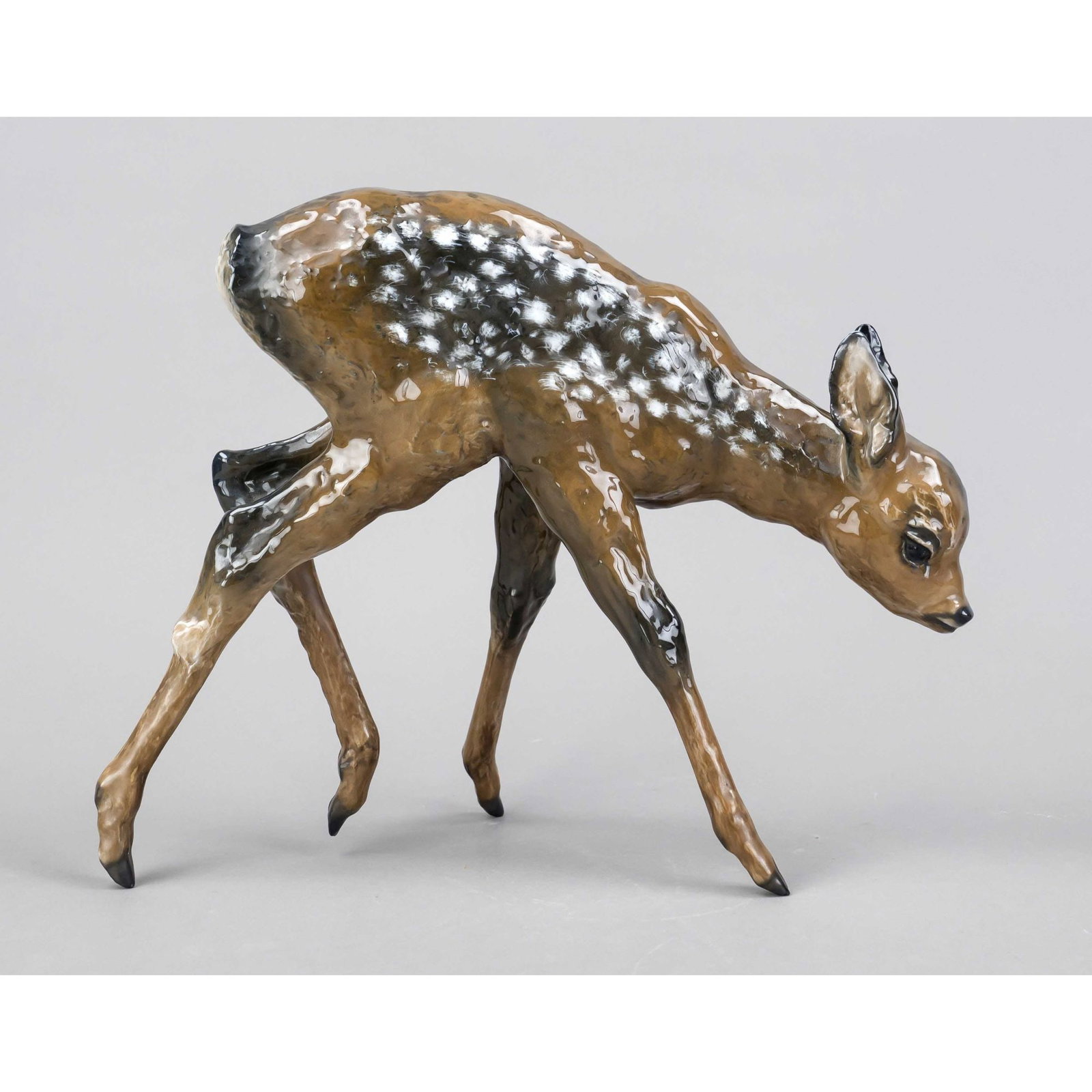 Large Bambi, Rosenthal, mark of t: Large Bambi, Rosenthal, mark of the art department in Selb for 1939, design heidenreich, u. marked, standing deer, polychrome painted in naturalistic underglaze colors, h. 28 cm. L. 34 cm