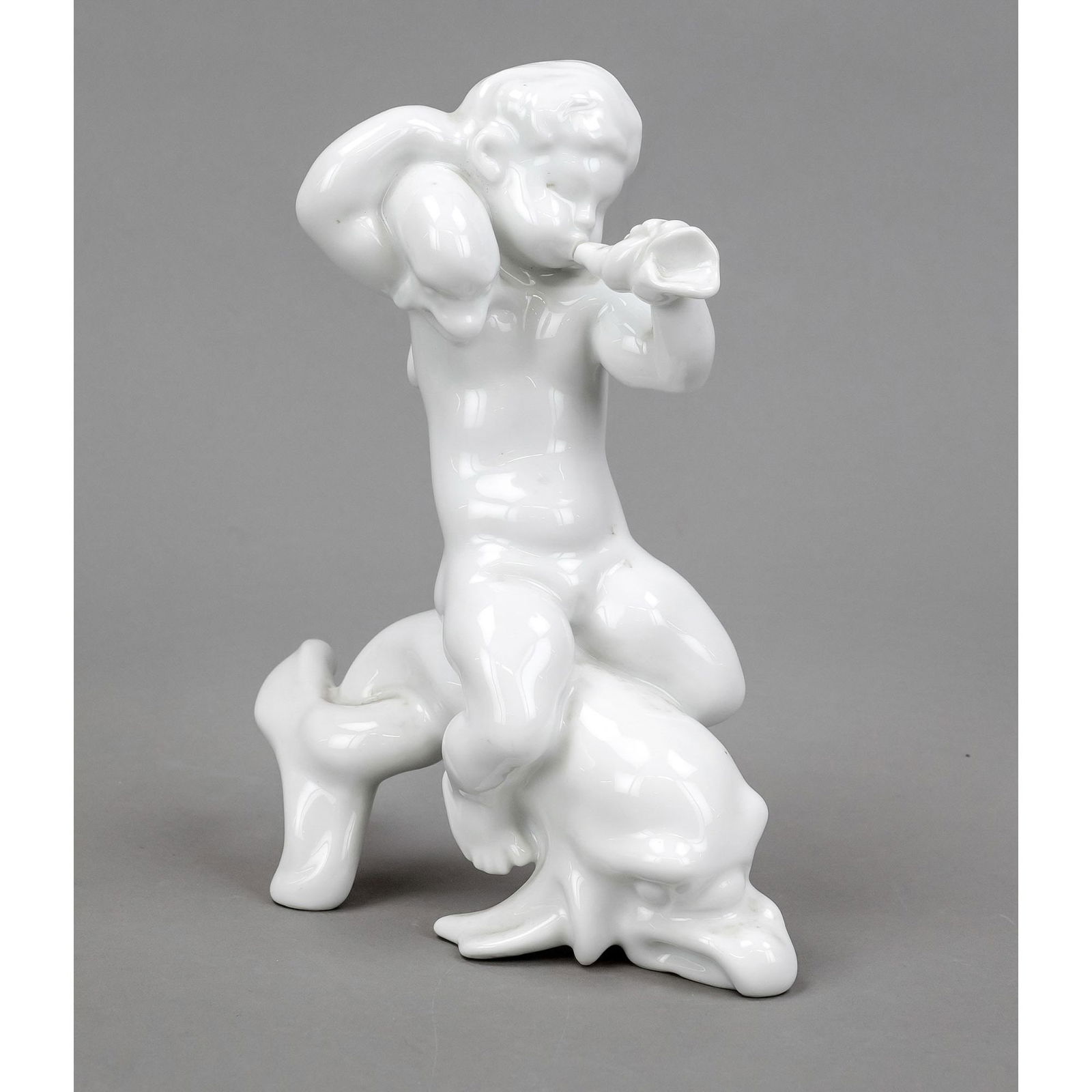 Putto on dolphin, blowing into a: Putto on dolphin, blowing into a conch shell, Bing & Gröndahl, Copenhagen, 20th century, 2nd choice, white, designed by Kai Nielsen (1882-1924), model no. 4059, crack to conch shell (without loss of