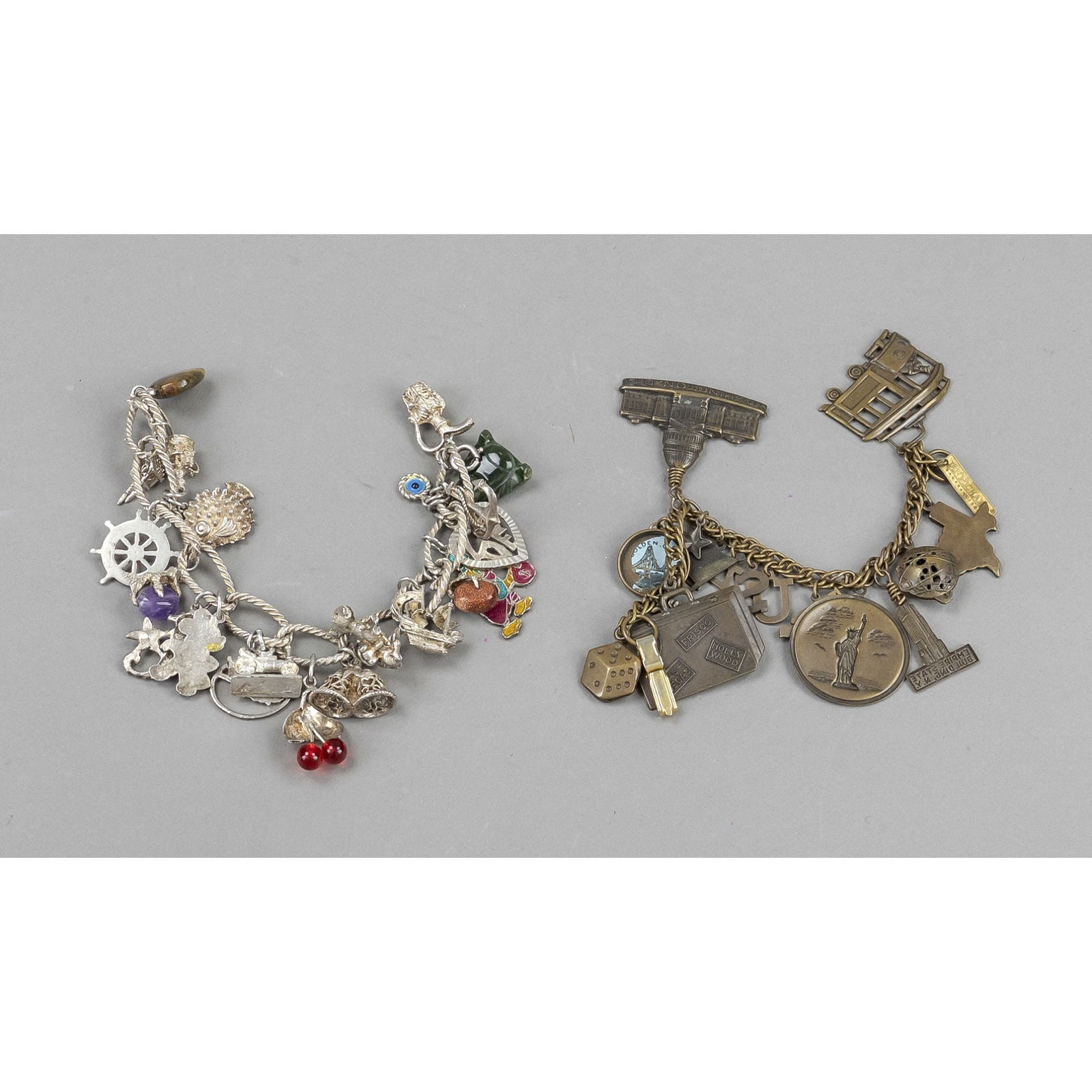 Two vintage costume jewelry charm: Two vintage costume jewelry charm bracelets, silver and bronze-coloured metal, various pendants, one with American travel souvenir motifs, partially tarnished, l. approx. 19 cm and 20 cm respectively