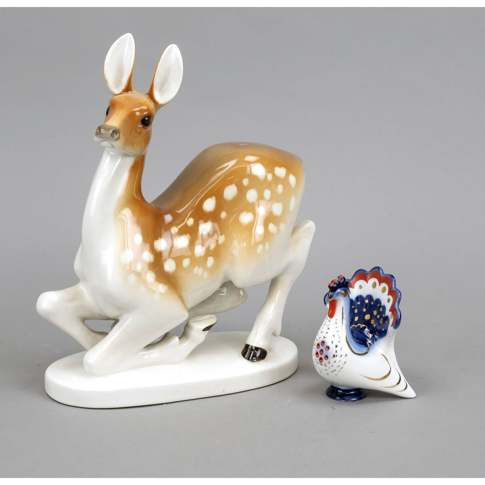 Deer and rooster, Lomonossov manufactory: Deer and rooster, Lomonossov manufactory, St. Petersburg, 1970s. Kneeling roe deer, designed by Vorobjuov in the 1960s, ear restored, h. 25 cm. with rooster as figurative salt cellar, h. 9 cm, both po